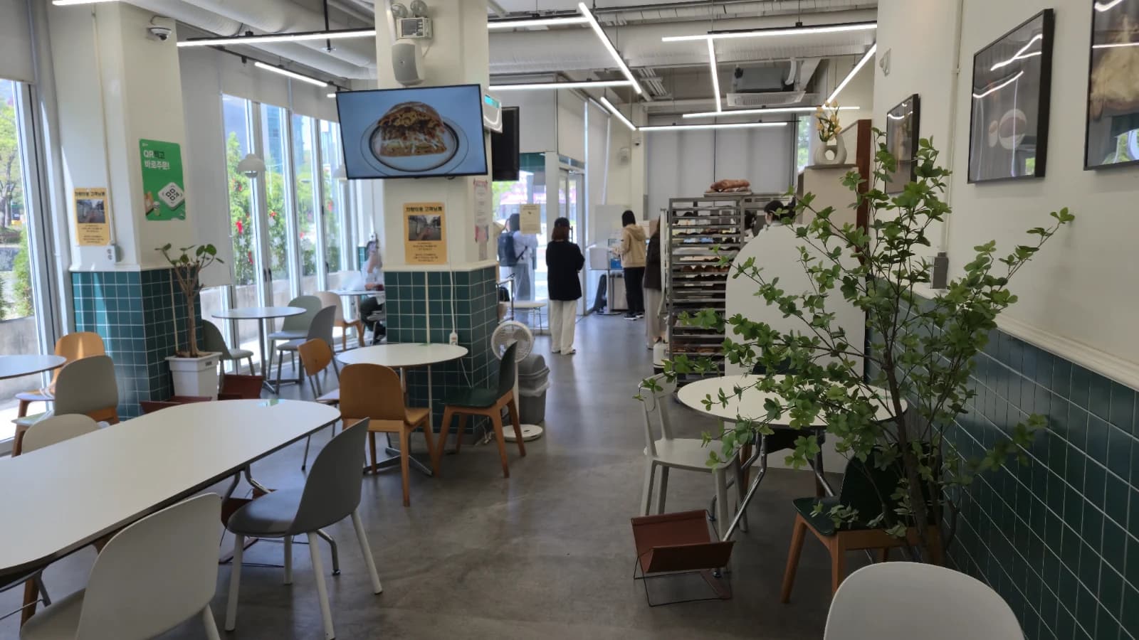 Green Bakery interior with green tile walls and seating area