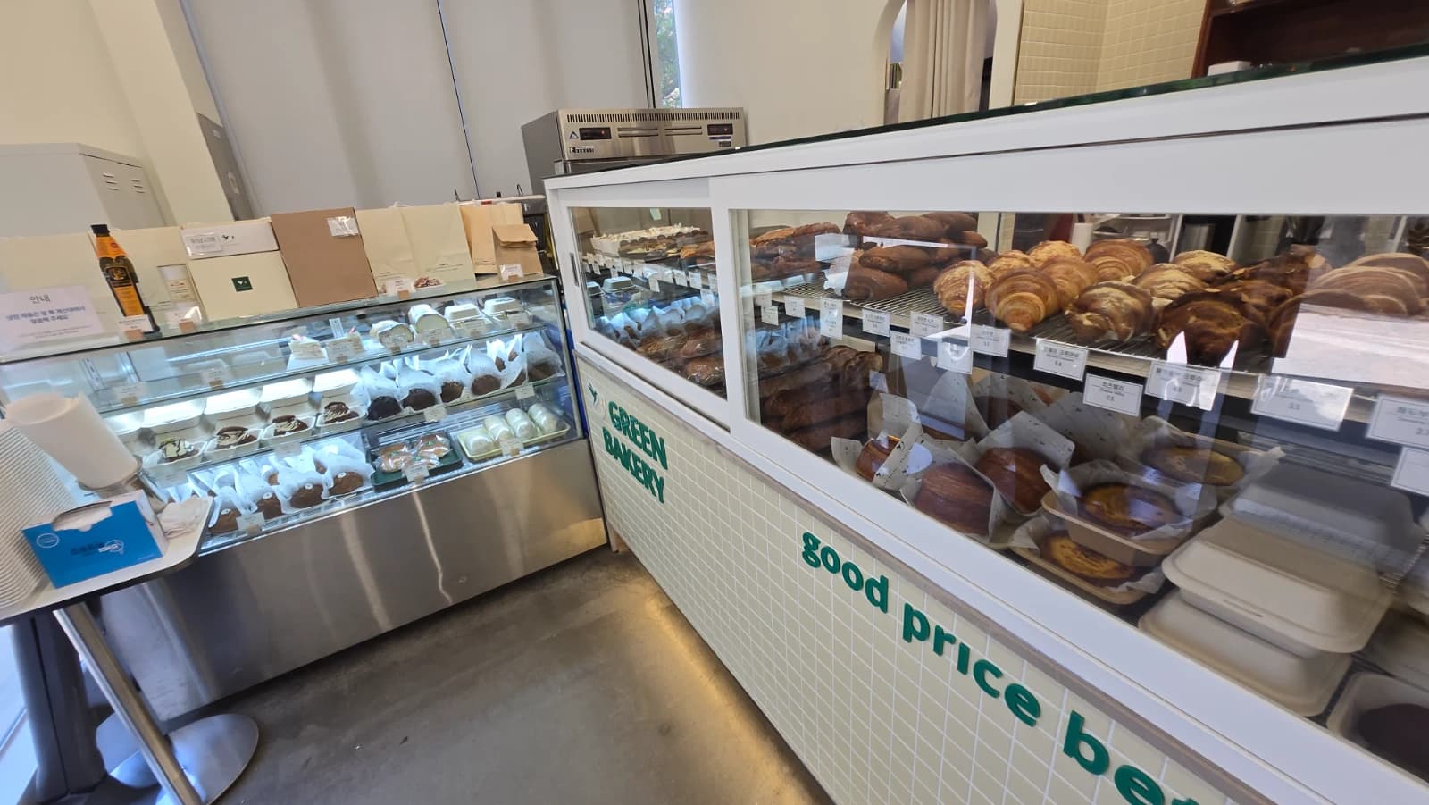 Green Bakery full display case packed with a wide variety of fresh bread