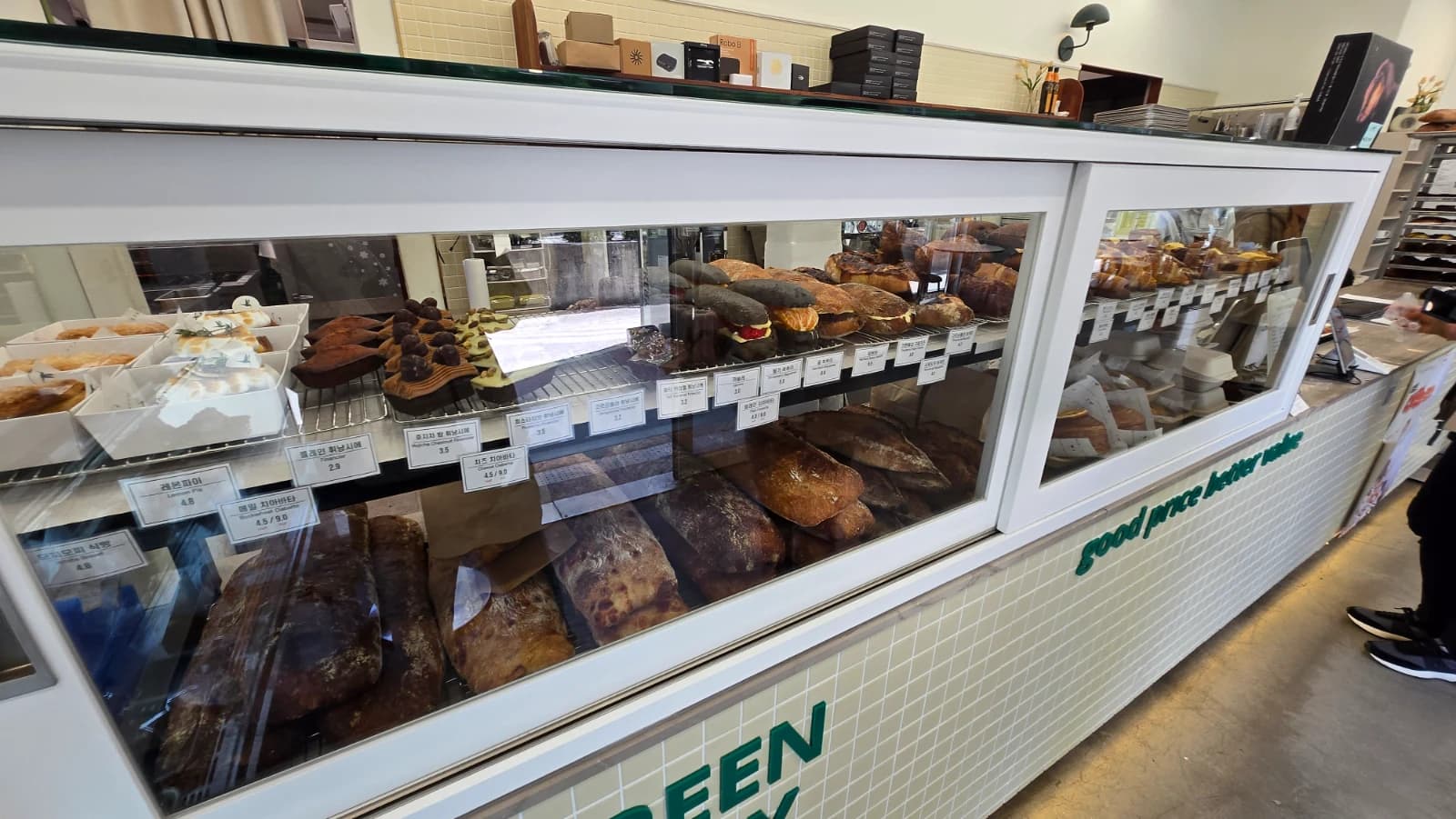 Green Bakery glass case with assorted tarts and desserts