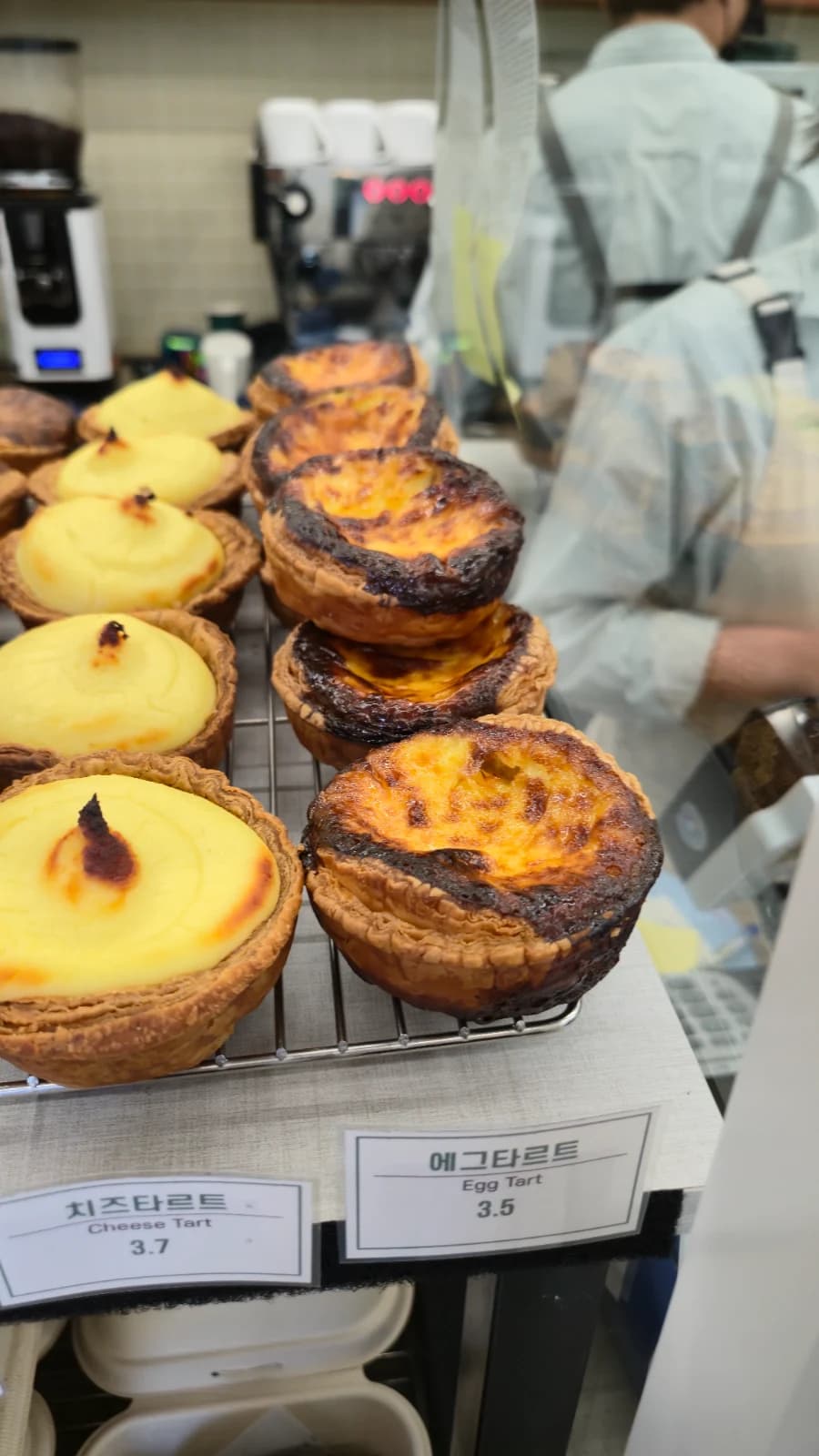 Green Bakery egg tart about three dollars with deeply caramelized top