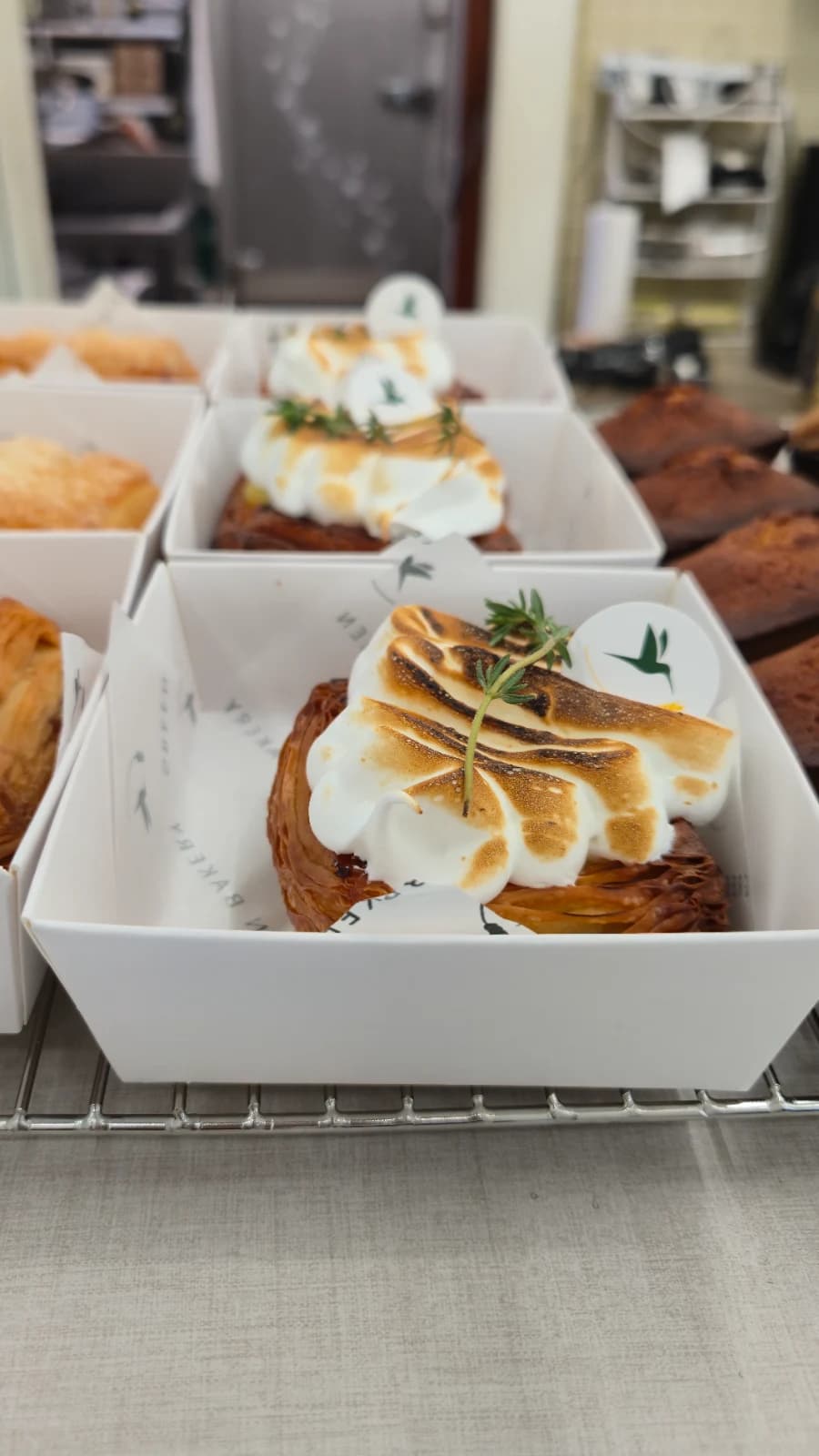Green Bakery torched meringue croissant garnished with herbs