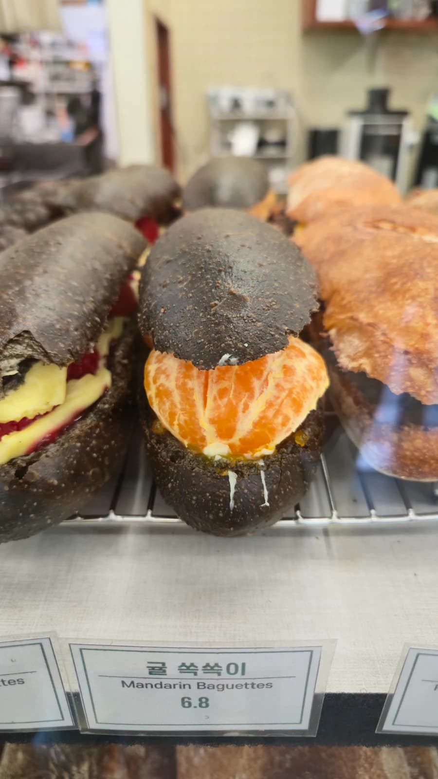 Green Bakery mandarin ssokssoogi with whole citrus in squid ink dough about five dollars