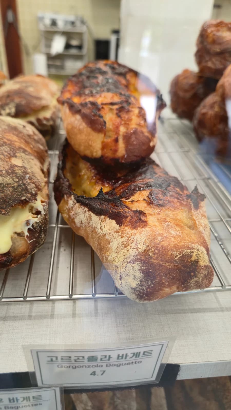 Green Bakery gorgonzola baguette with melted cheese on the charred crust about three fifty