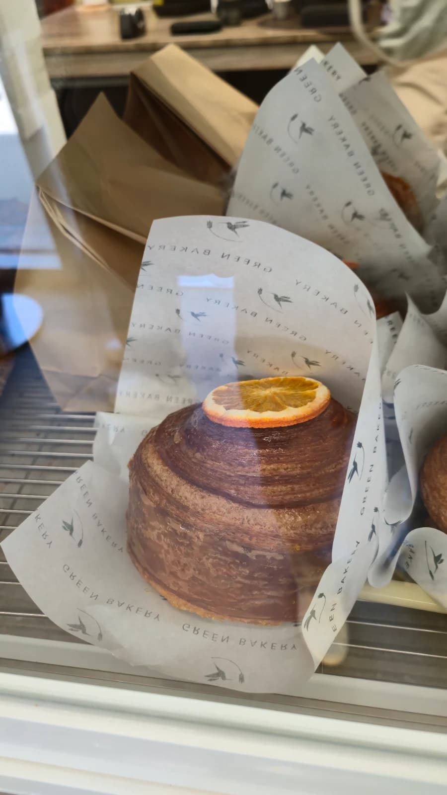 Green Bakery croffin topped with dried orange slice