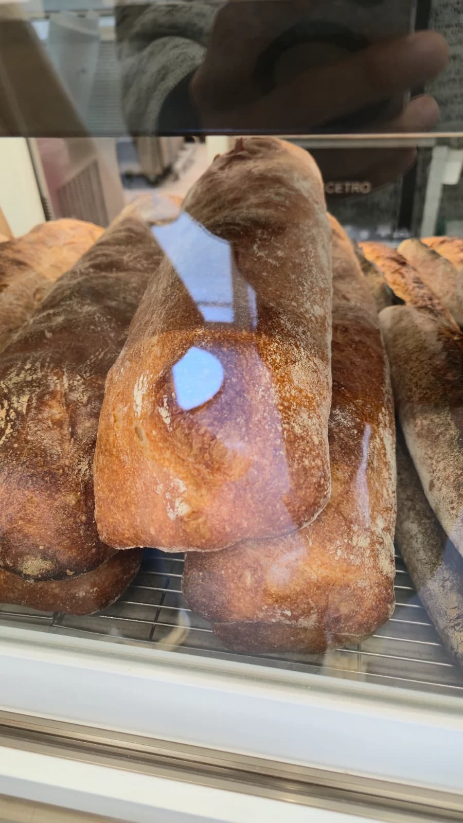 Green Bakery handmade baguette with natural flour dusting and cracks