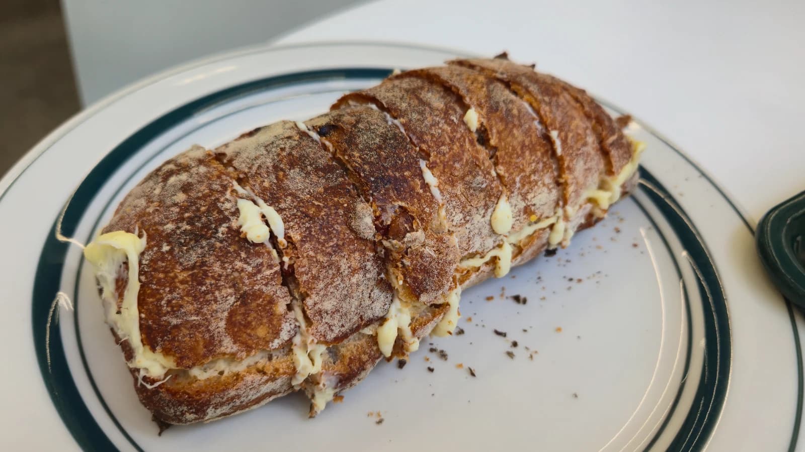 Green Bakery cranberry cream cheese baguette with cream oozing from the slits