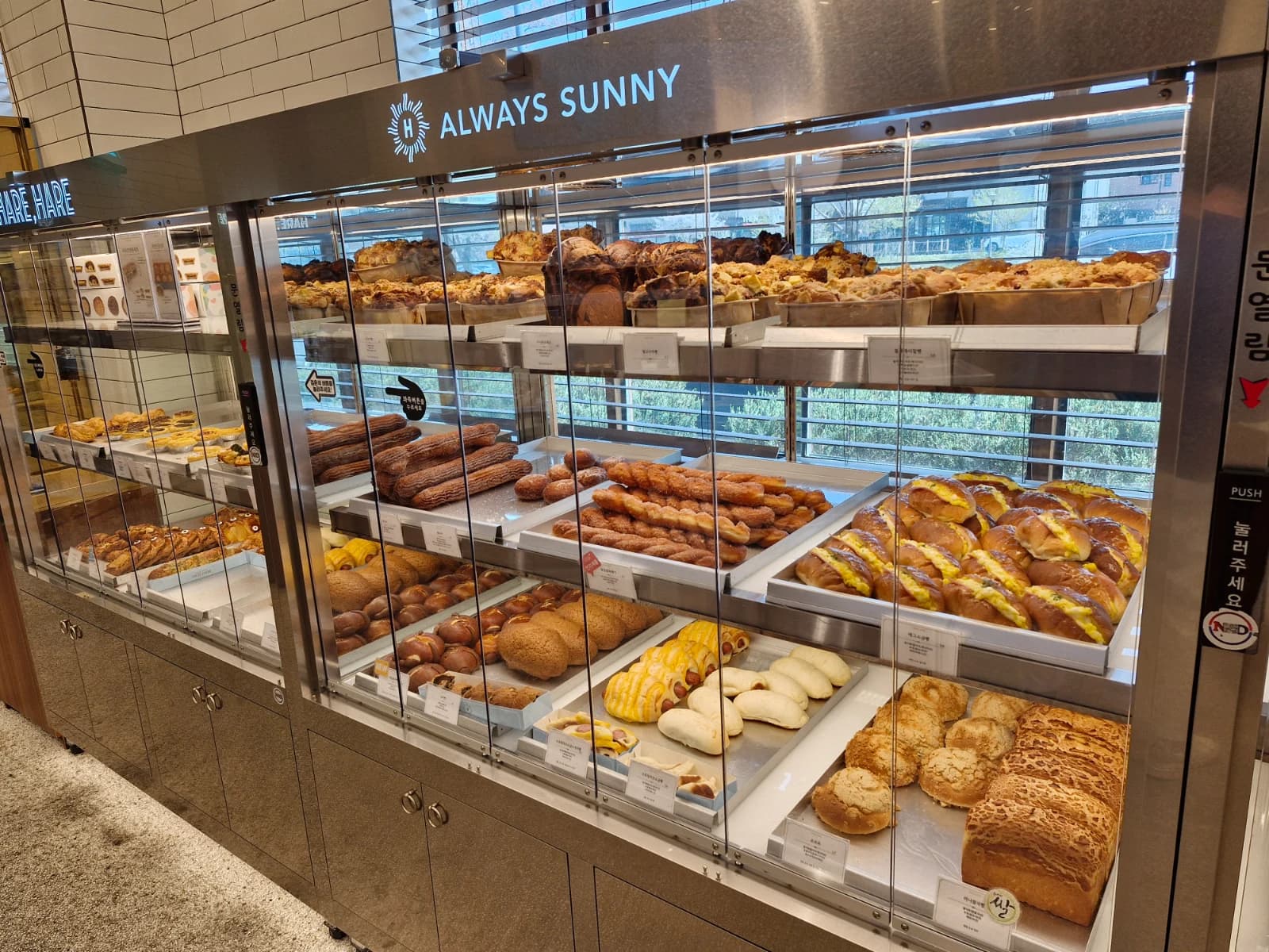 Sweet pastry display with eclairs and soboro bread