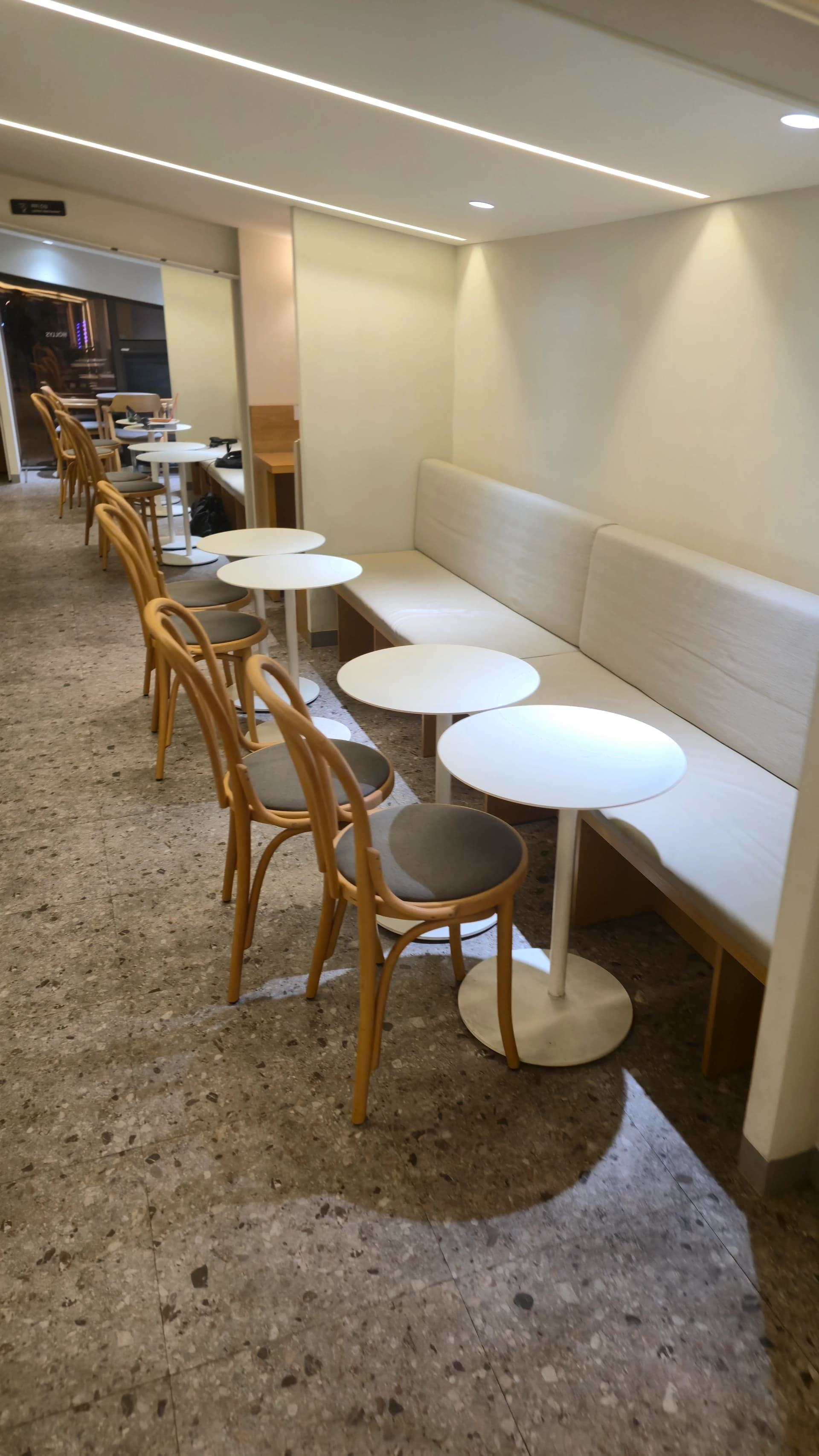 할리스 2층 벽면 소파와 원형 테이블이 배치된 2인 좌석 구역