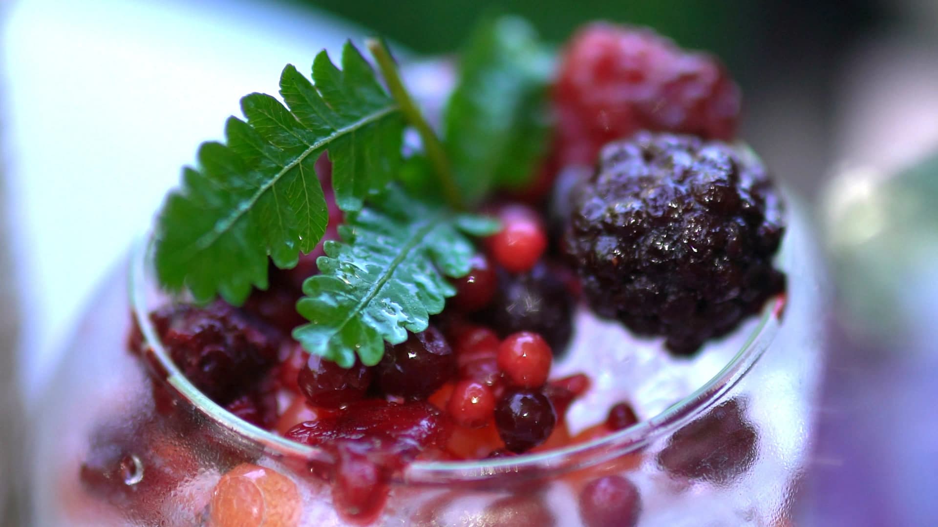 Close-up of fresh mixed berries stacked on ice in a cafe berry drink