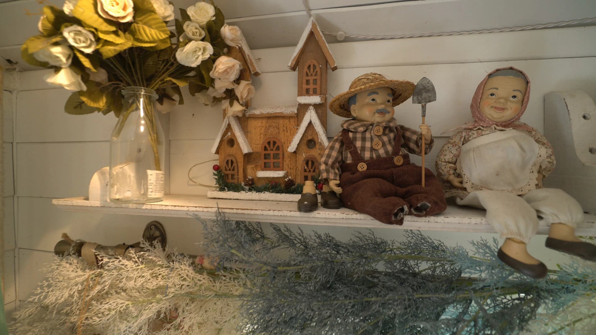 Handmade straw hat grandpa doll and headscarf grandma doll sitting side by side