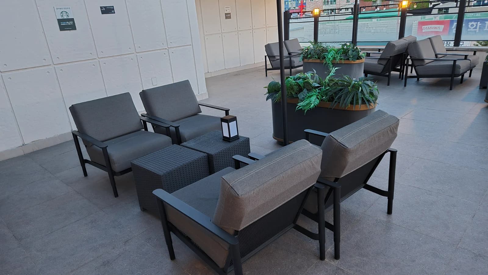 Disposição dos assentos no terraço do Starbucks coreano com sofás e mesas laterais