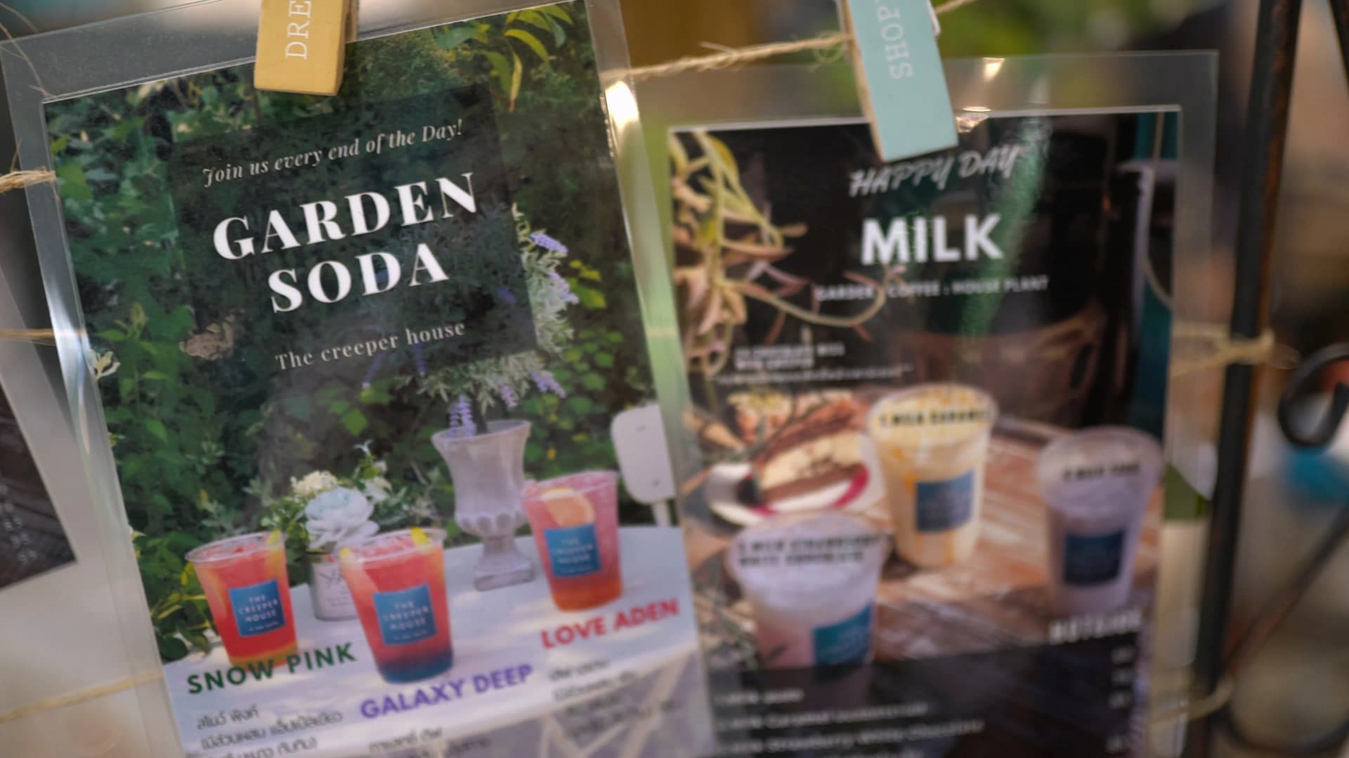 Close-up of The Creeper House menu cards showing drink names Snow Pink, Galaxy Deep, and Love Aden