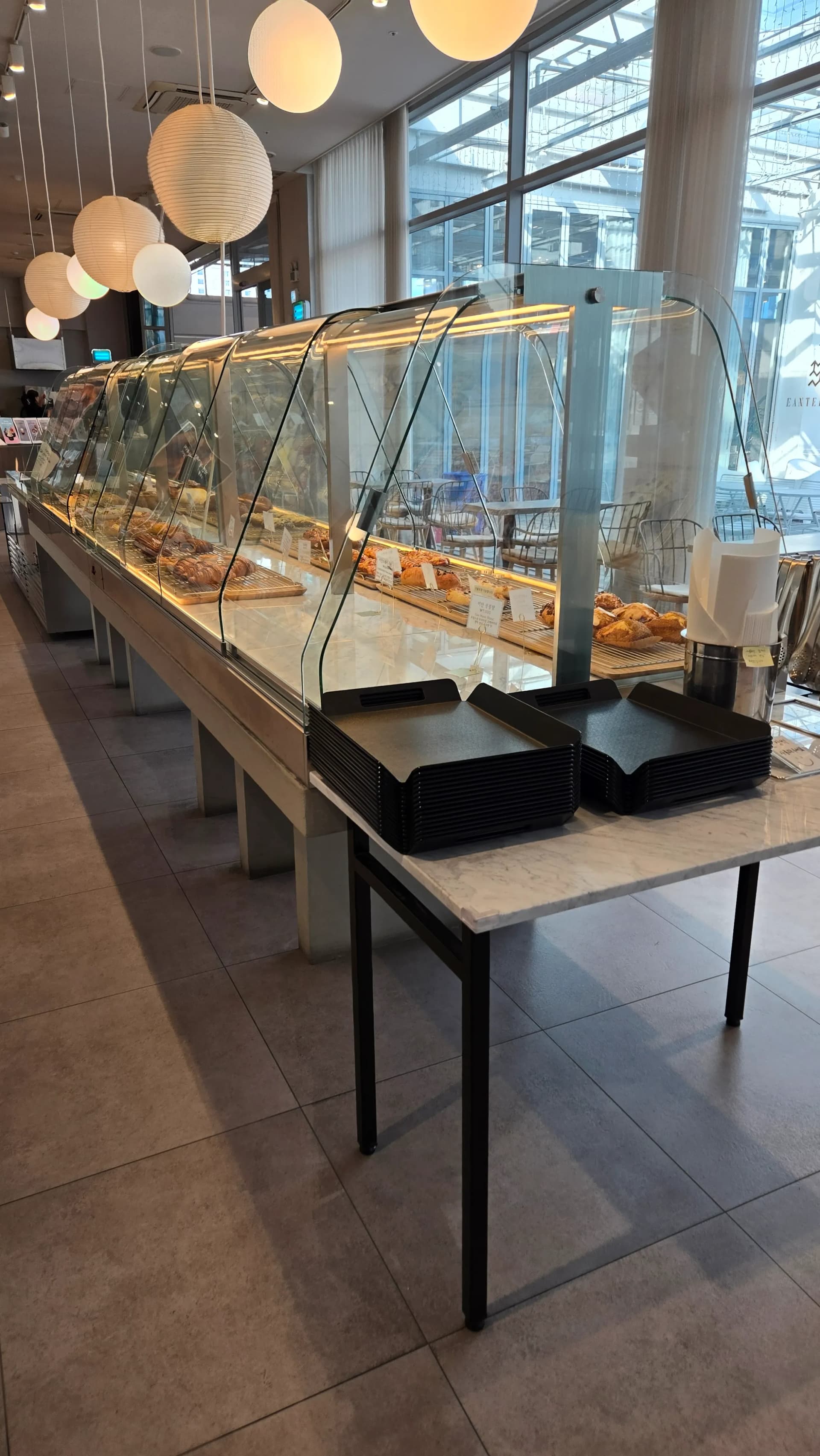 Vitrin iko lụrụ ogwe (curved) jupụtara n’ụdị achịcha bakery dị iche iche n’ime Ean Terrace | 하이제이에스비