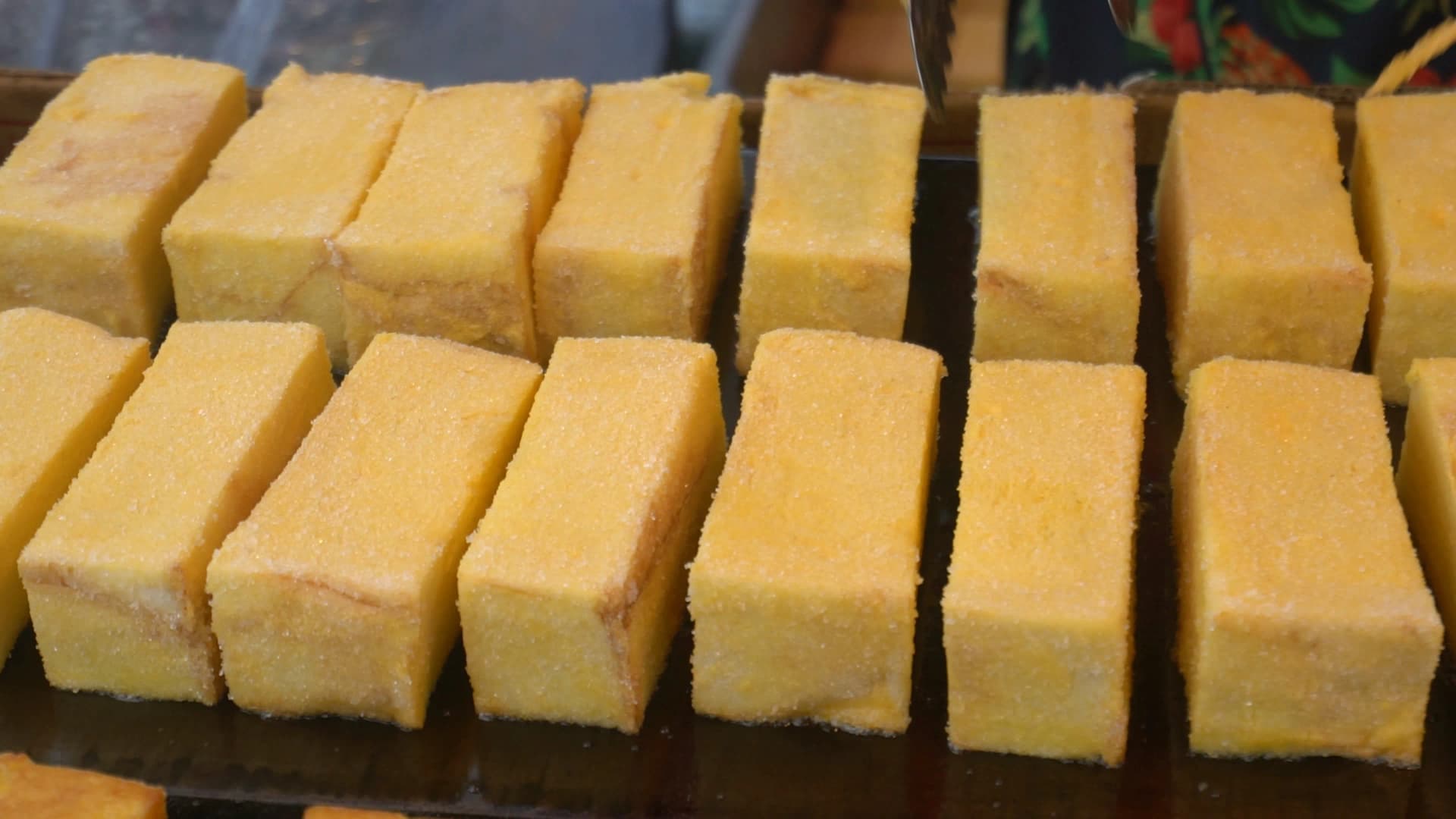 태국 재래시장 식빵 튀김 진열 – 노란색 식빵 튀김이 줄줄이 늘어선 모습