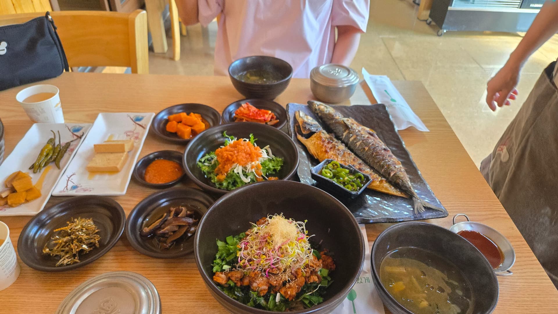 Mwonekano kamili wa meza iliyojaa ya Gyeongchunjae na bibimbap ya clam na samaki wa makrill wa kuchoma | 하이제이에스비