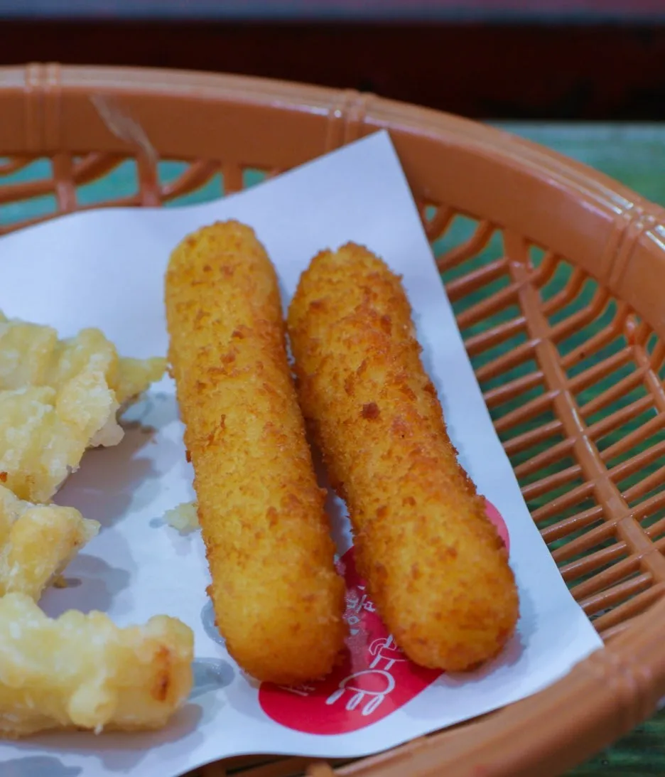 Golden breadcrumb-coated cheese sticks close-up side by side | 하이제이에스비