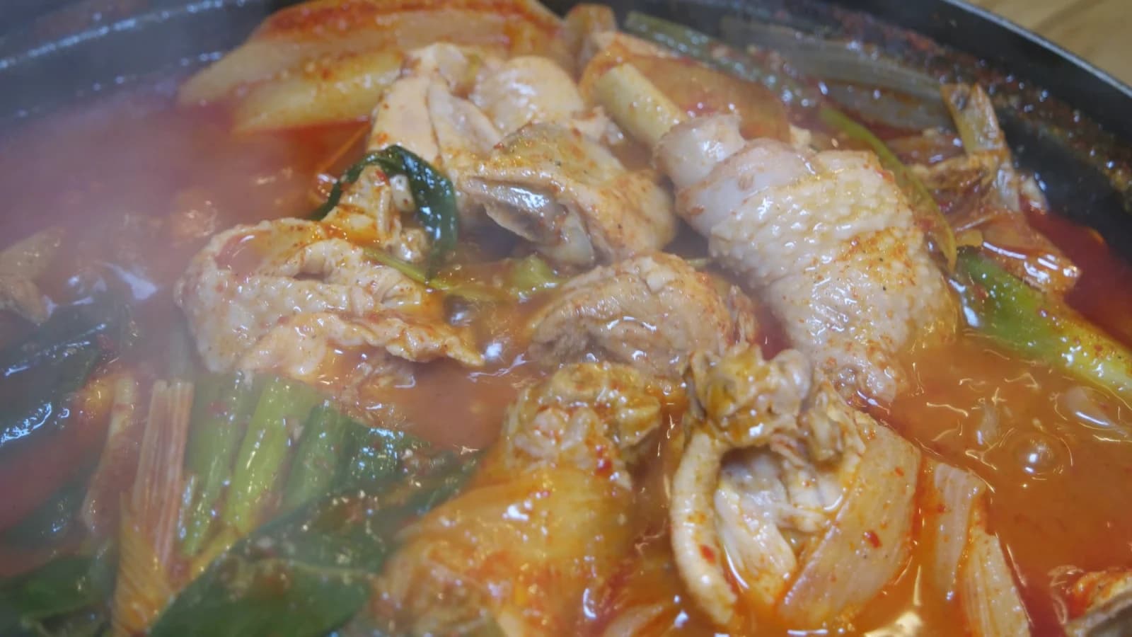Dakbokkeumtang with broth reduced to a thick glaze, drumsticks and wings exposed above the liquid line