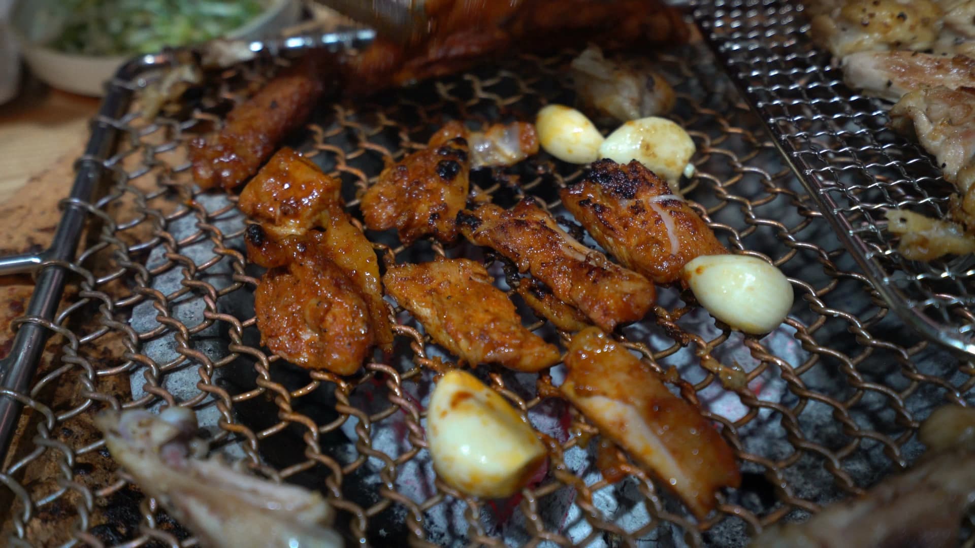 Gochujang marinated dakgalbi with slightly charred caramelised edges from charcoal grilling