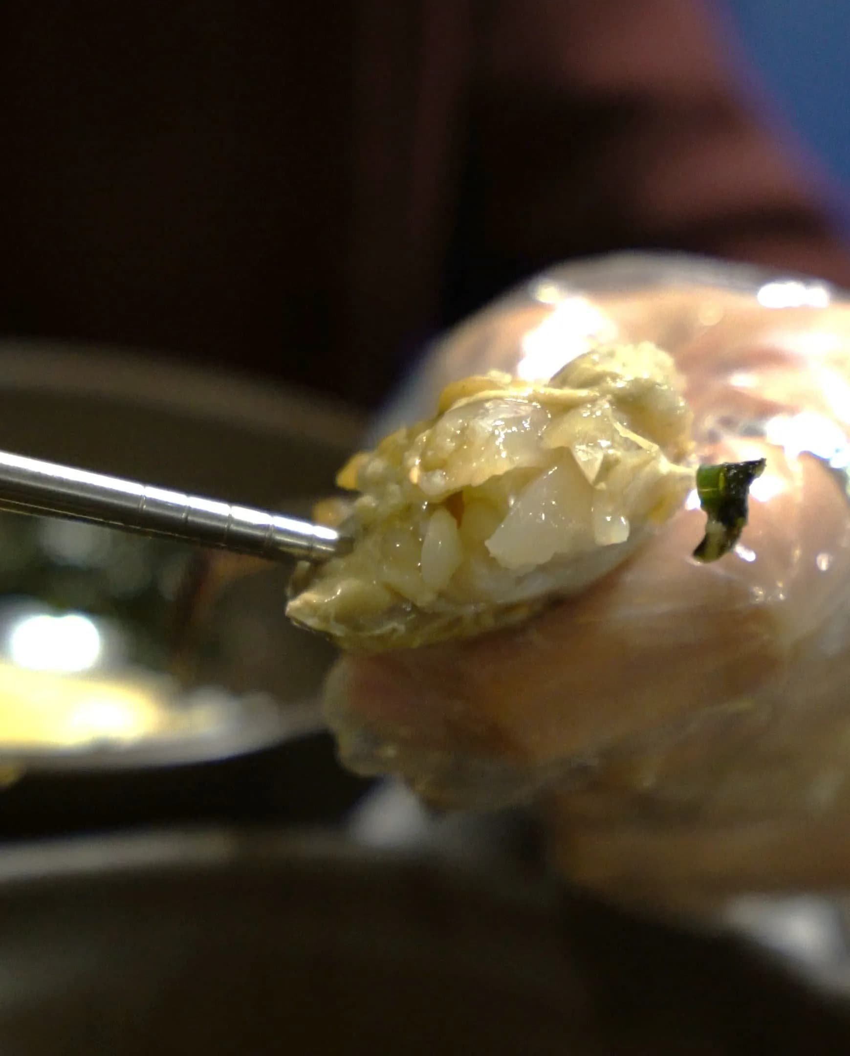 Flipped crab shell showing innards and roe cured in soy sauce with a thick glossy texture