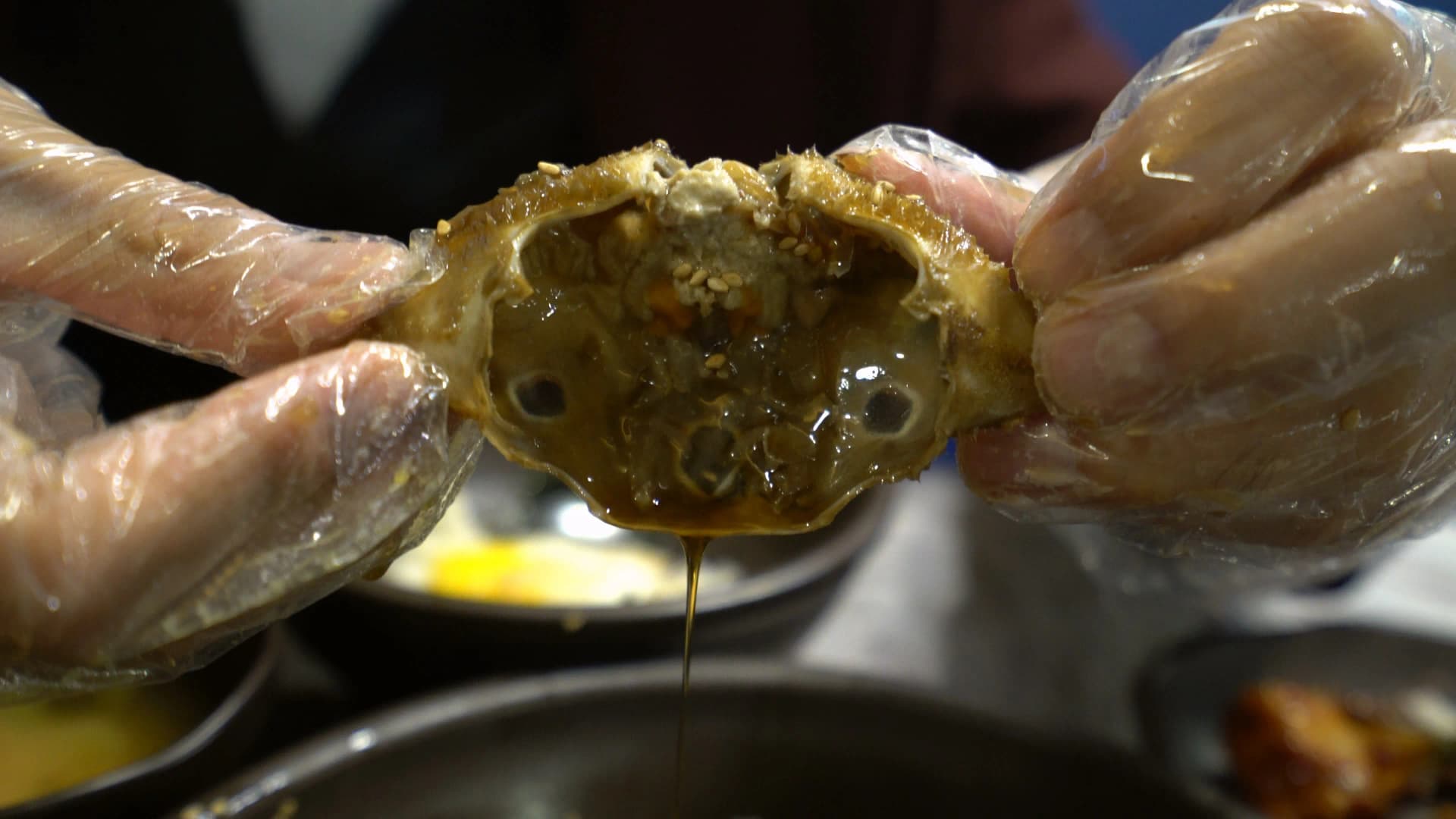Crab shell filled with white rice mixed with soy-cured roe and innards making crab shell bibimbap