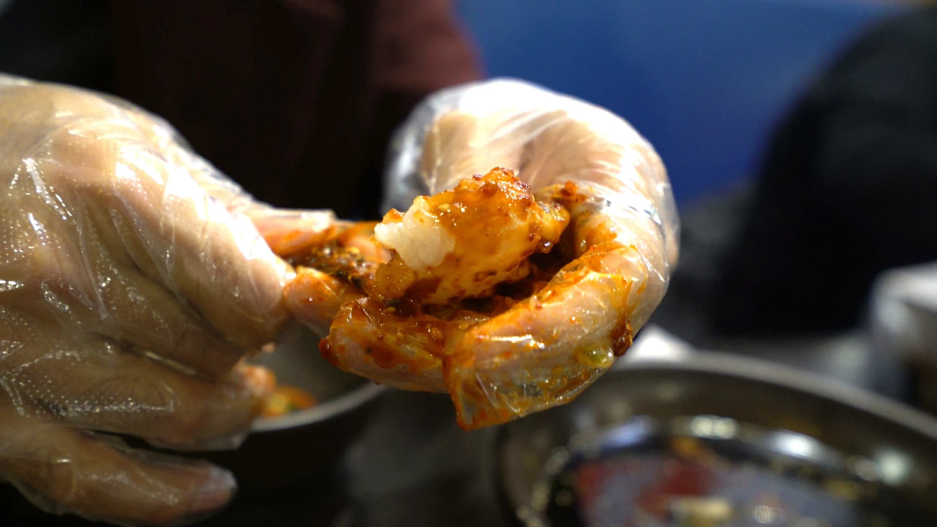 Yangnyeom gejang crab meat close-up with plump white flesh visible beneath red spicy marinade