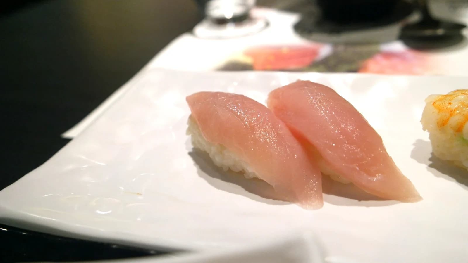 Flounder nigiri sushi with pale pink, firm-textured flounder on rice