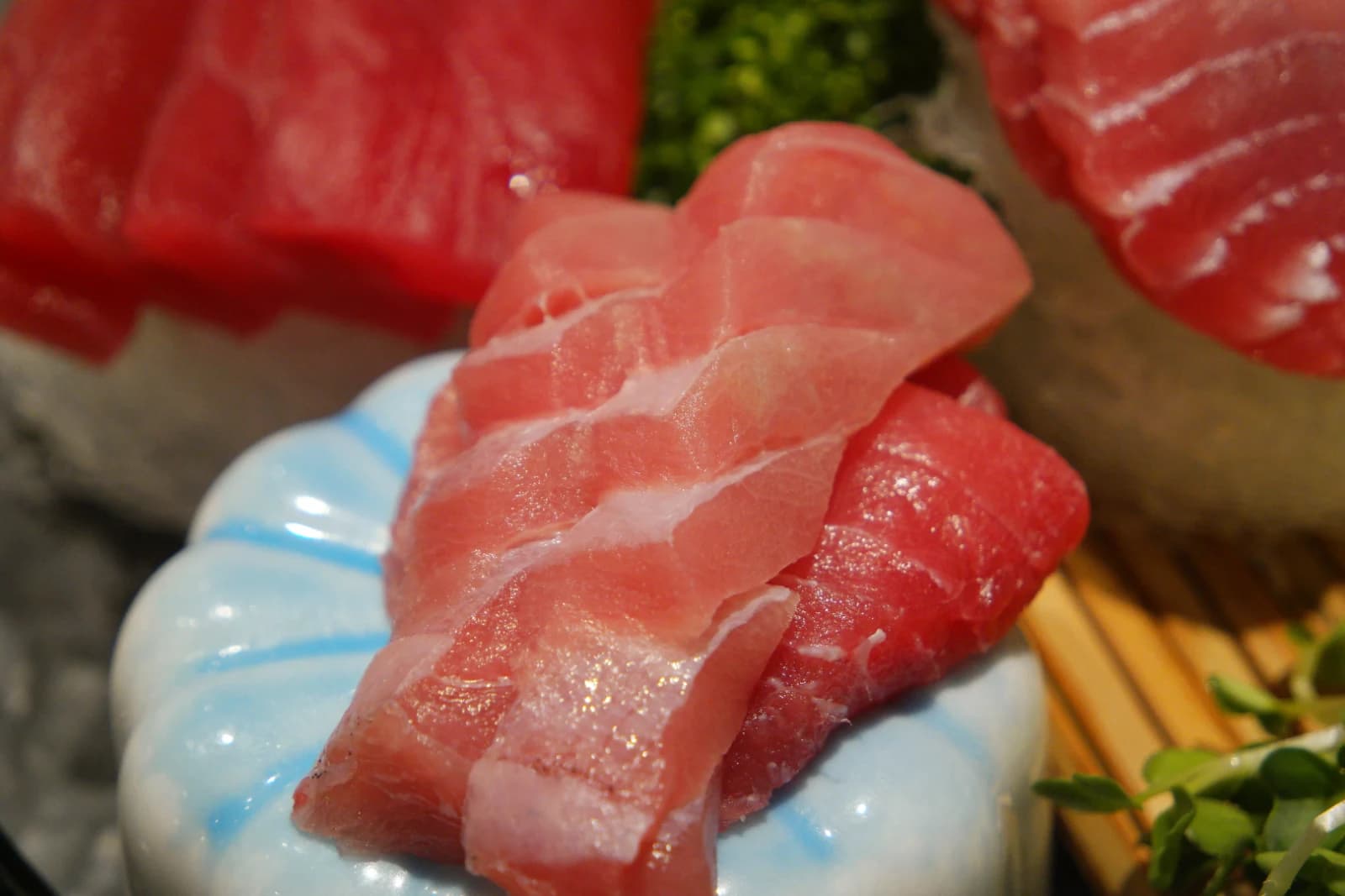 Premium fatty tuna belly sashimi, almost pink in color with dense white striations throughout