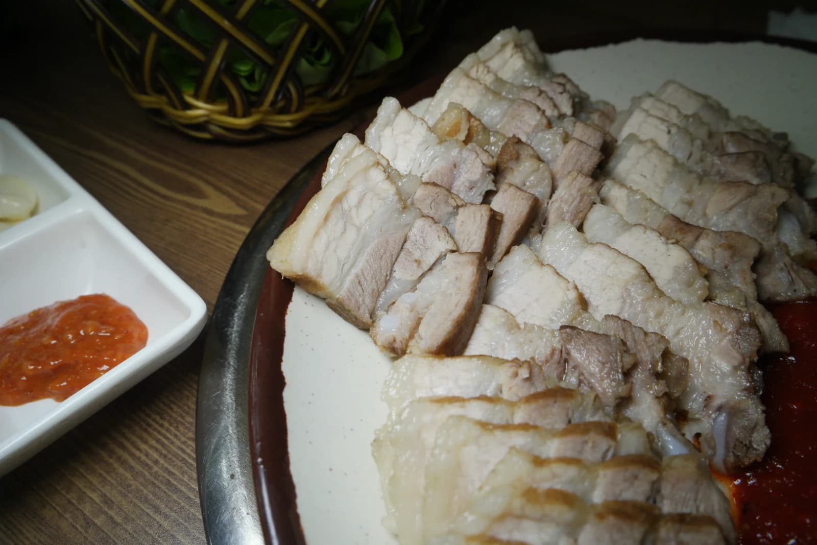 Thinly sliced bossam pork showing layers of lean meat and fat in cross-section