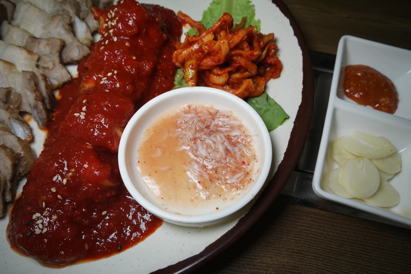 Small dish of salted fermented shrimp paste served alongside bossam