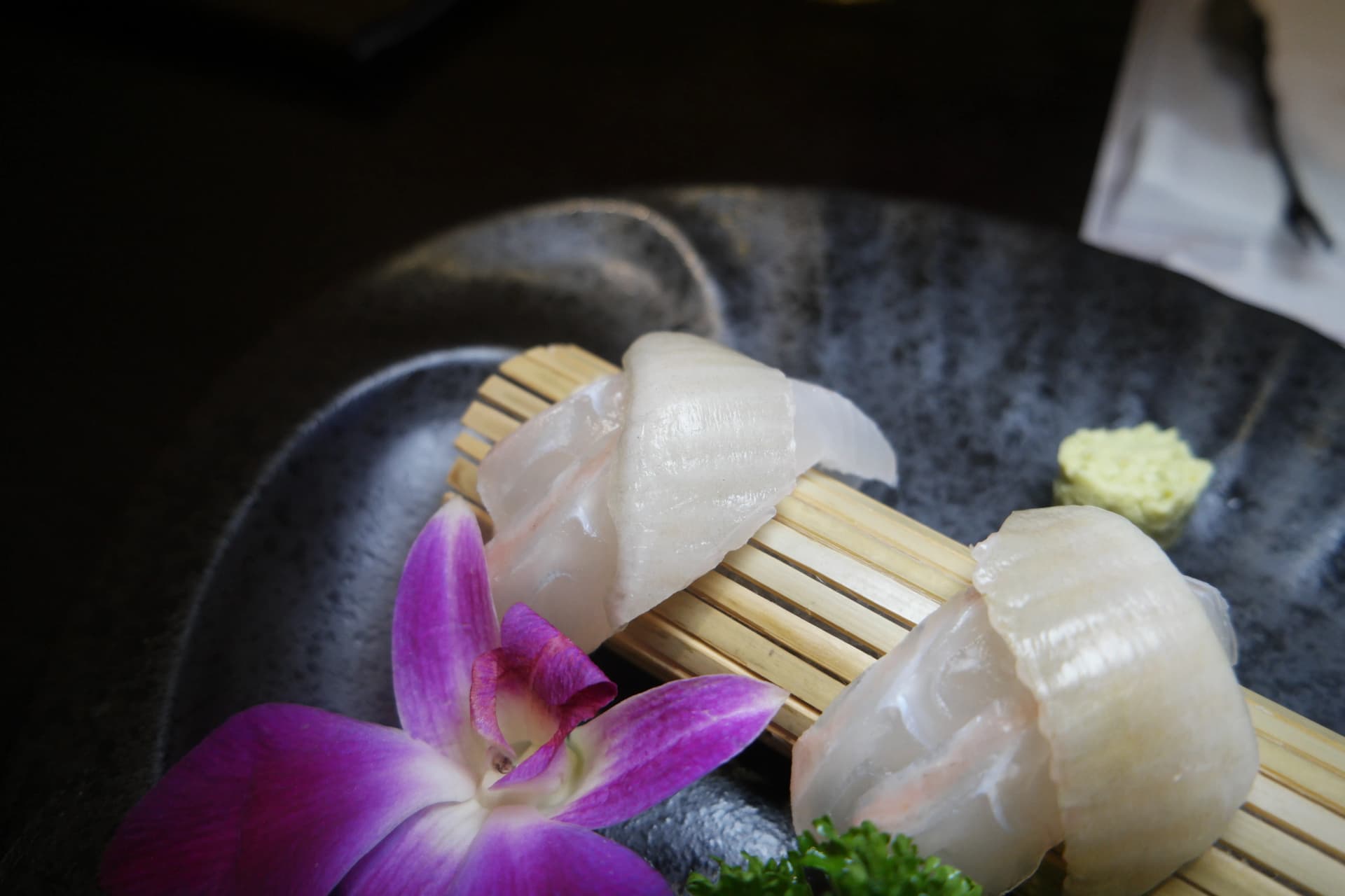 Presentación del sashimi de lenguado con flor de orquídea como decoración | 하이제이에스비
