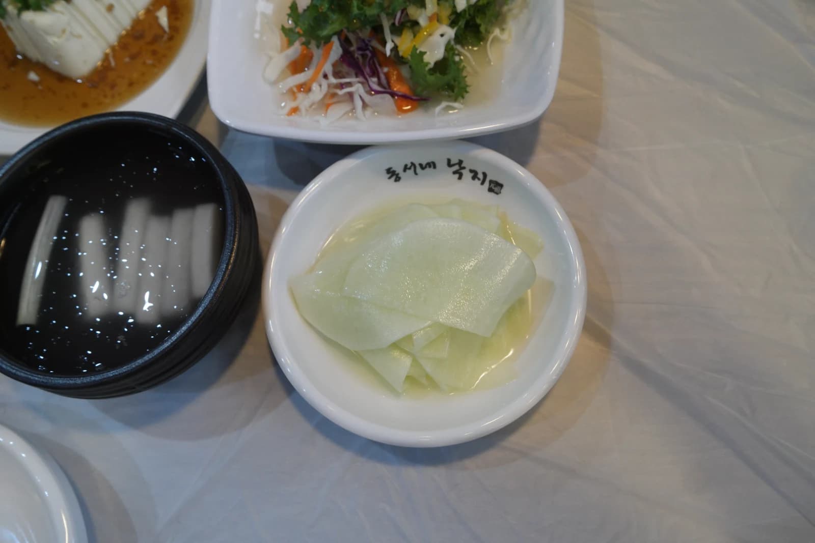 Thinly sliced radish pickled in vinegar served as a tangy Korean side dish called chomuchim