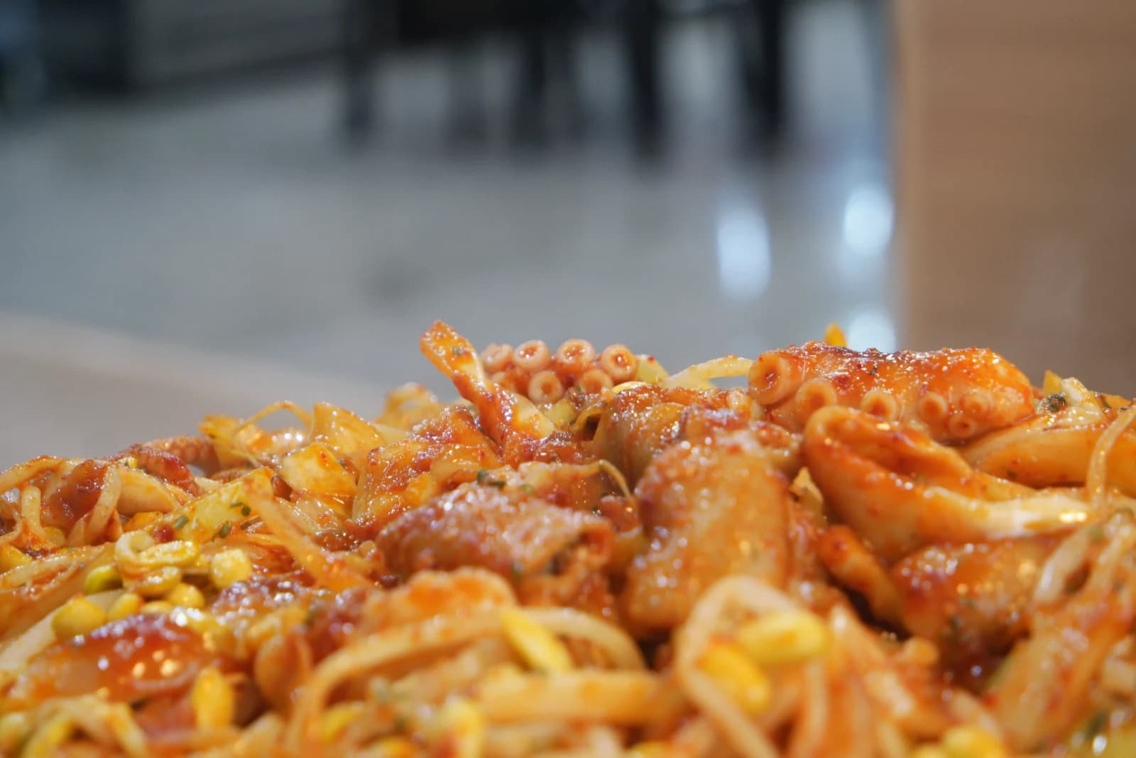 Spicy sauce-coated octopus legs and thick slices of beef intestine gopchang in the stir-fry