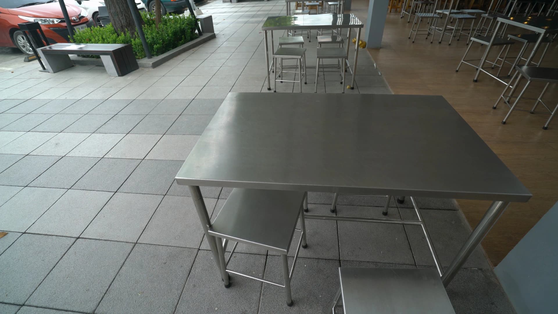 Thai PTT petrol station restaurant with stainless steel tables and chairs in a semi-outdoor seating area