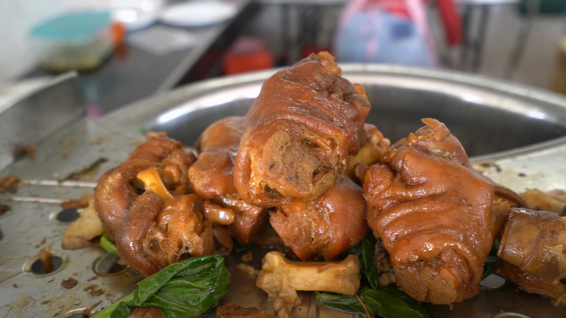 Thai khao kha moo whole braised pork leg glistening with dark soy glaze before slicing