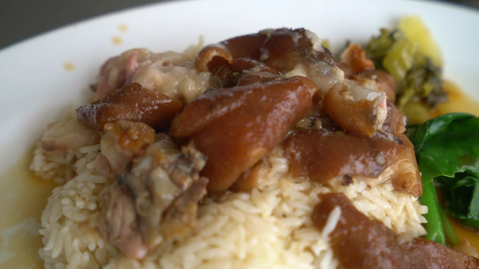 Complete khao kha moo Thai braised pork leg served over rice with braising sauce and bok choy