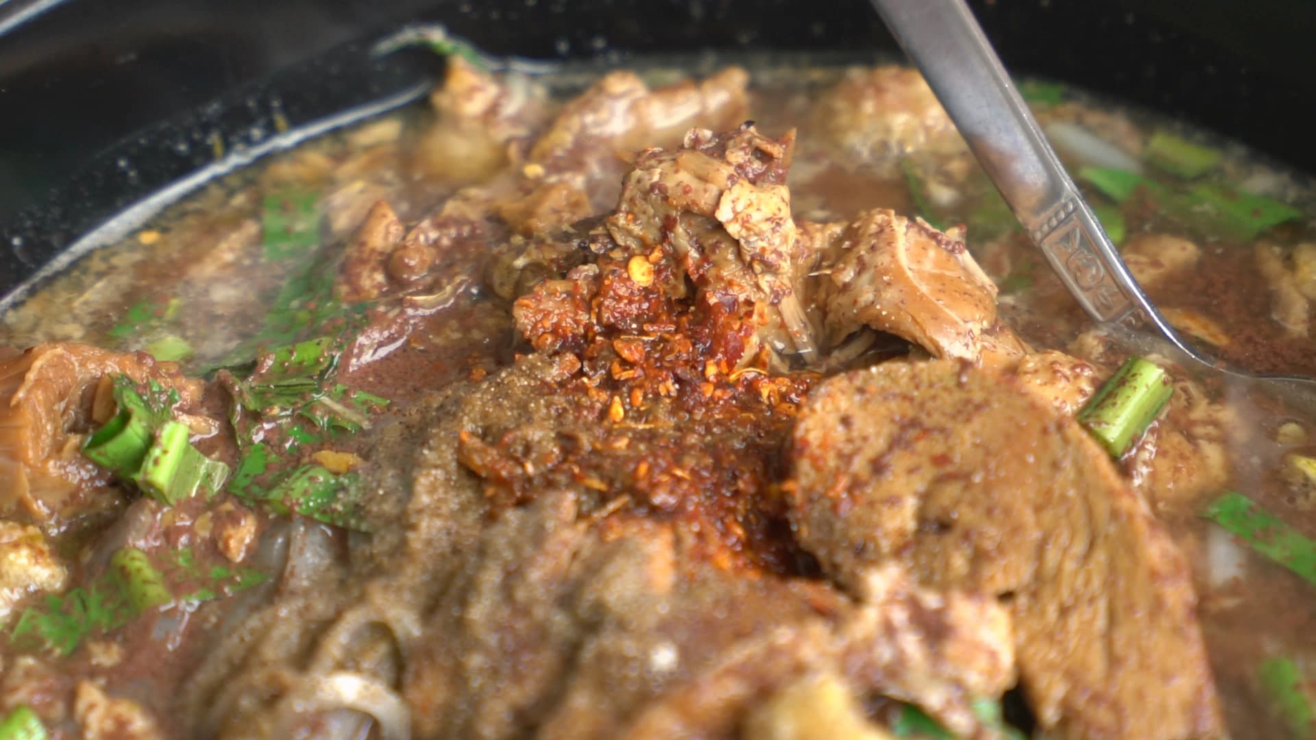 Thai kuay tiew nam tok pork blood broth noodle soup with dark rich broth in a bowl