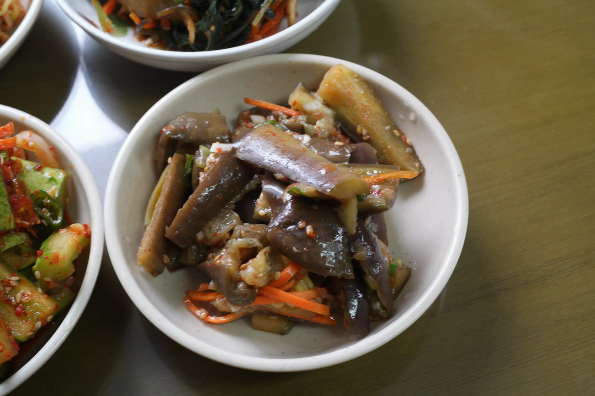 Steamed Korean eggplant dressed in soy sauce and sesame oil served as a soft silky side dish