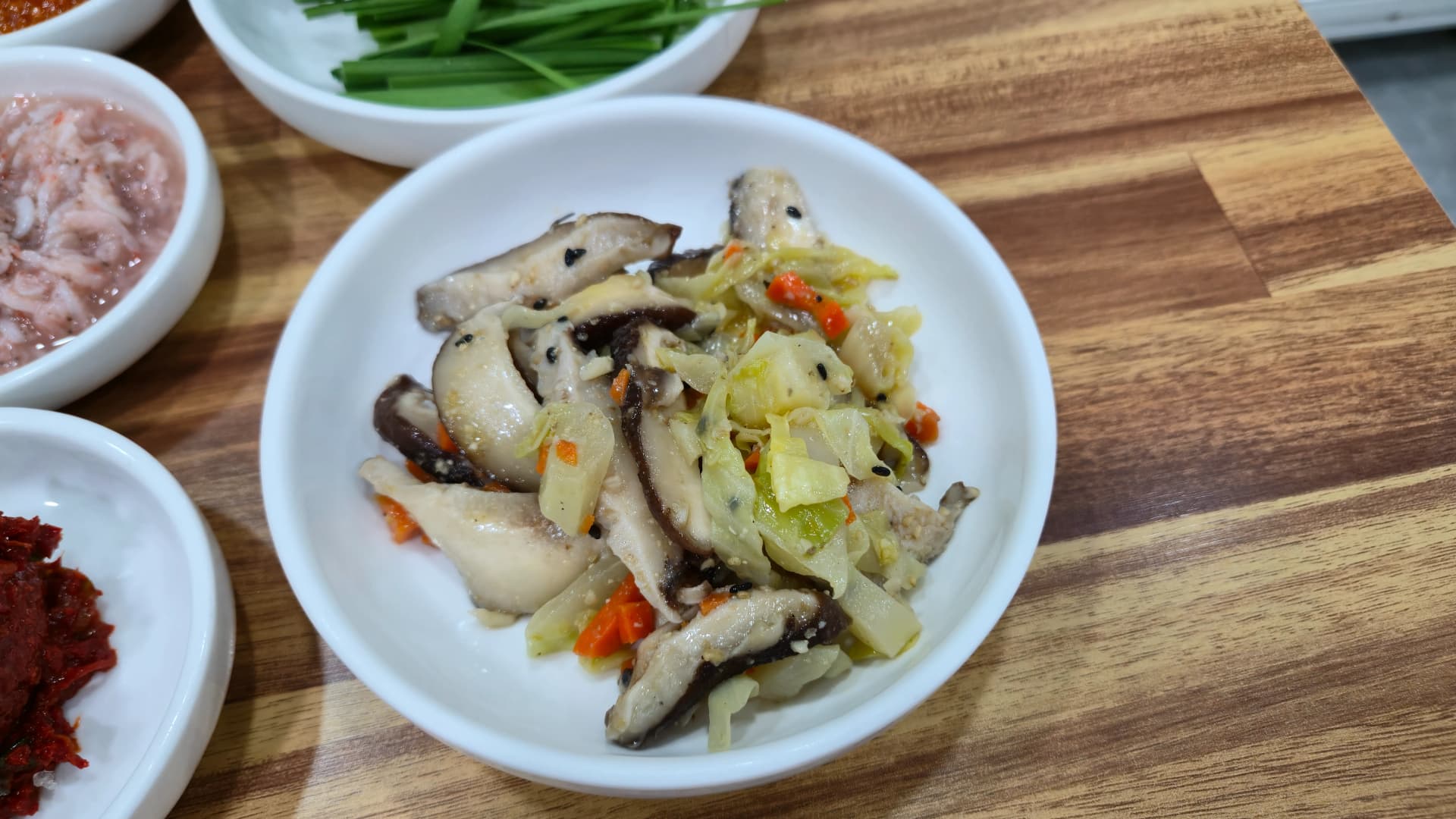 Sauteed mushroom side dish at a Korean soup joint showing how every restaurant serves different banchan