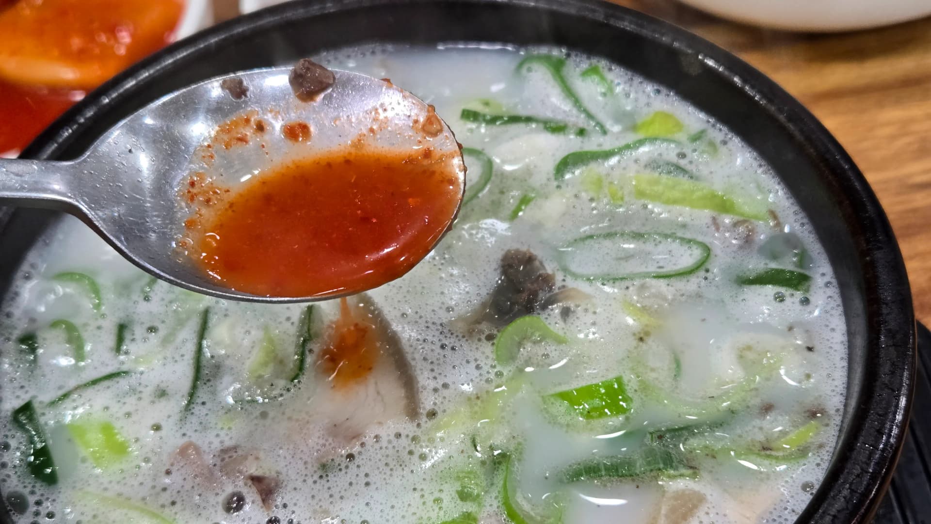 Sundaegukbap broth changing colour after adding kkakdugi juice creating a tangier pork soup