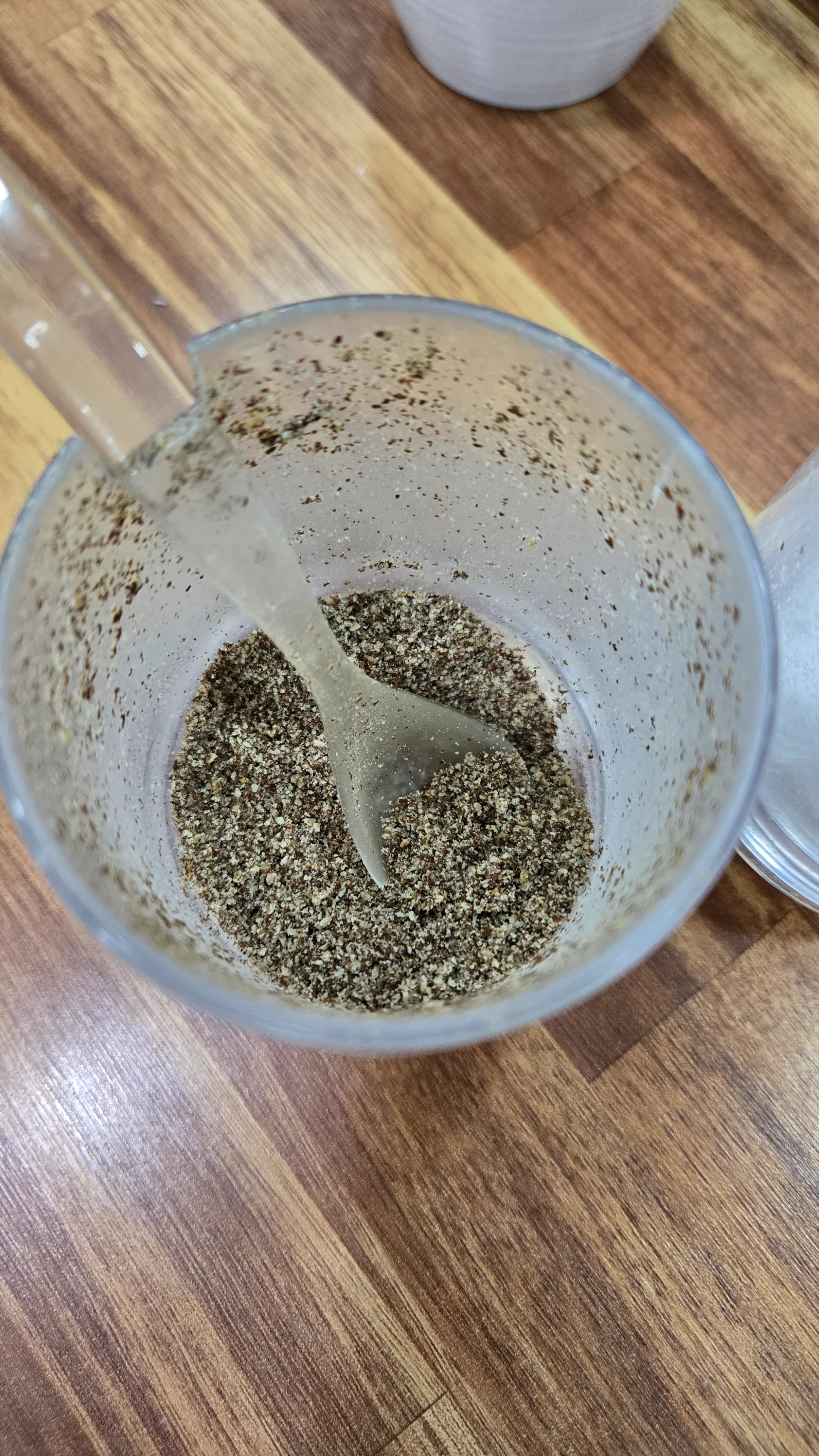 Sprinkling perilla seed powder into sundaegukbap to add nutty flavour and cut through the richness of the pork broth