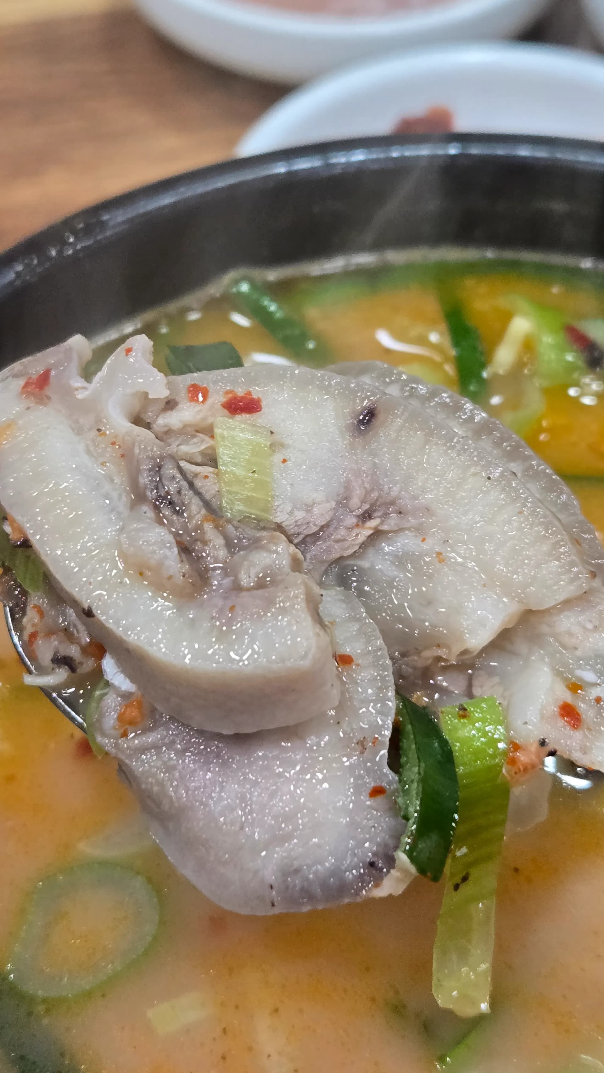 Various pork cuts inside sundaegukbap including boiled pork skin and head meat showing the textural variety