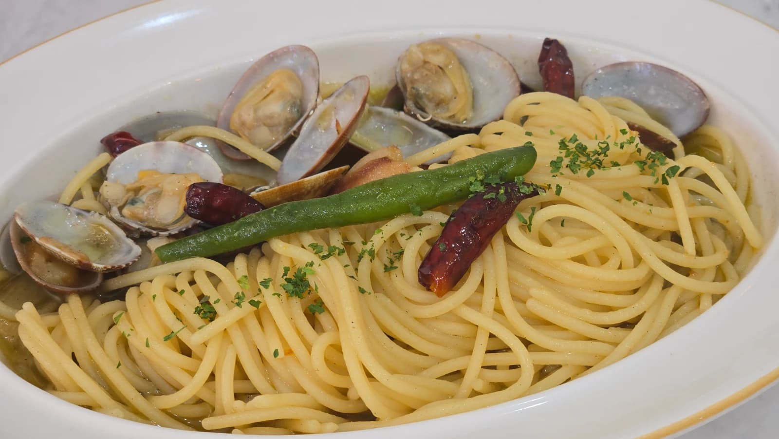 Full plate of Mitaly vongole pasta with clams and olive oil noodles