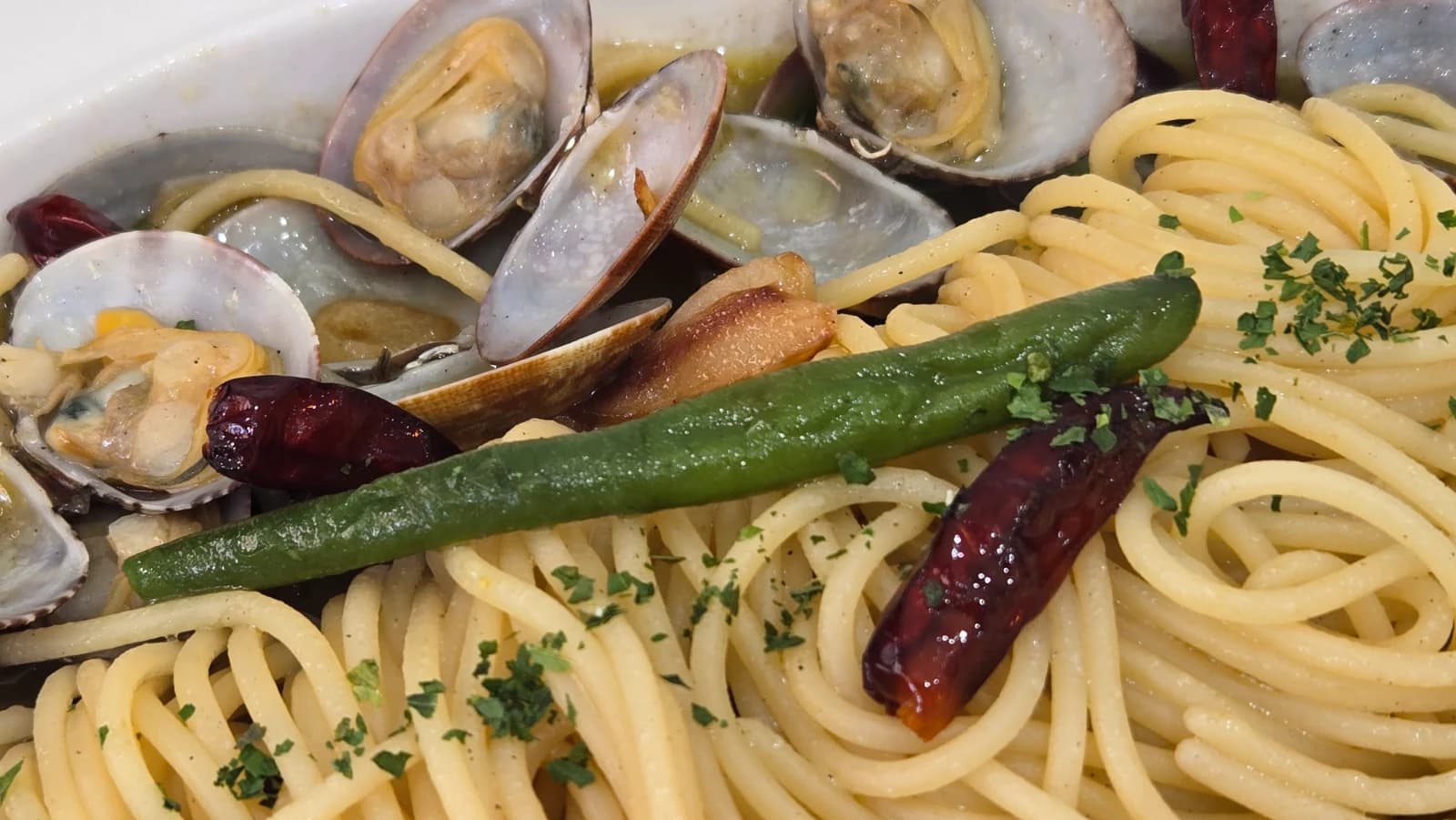 Close-up of open clam shells with plump meat in the vongole pasta