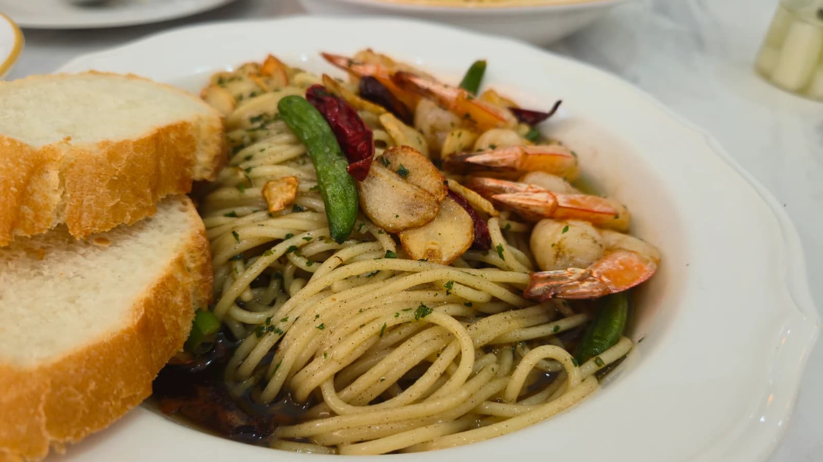 Close-up of gambas pasta noodles soaked in garlic-infused oil