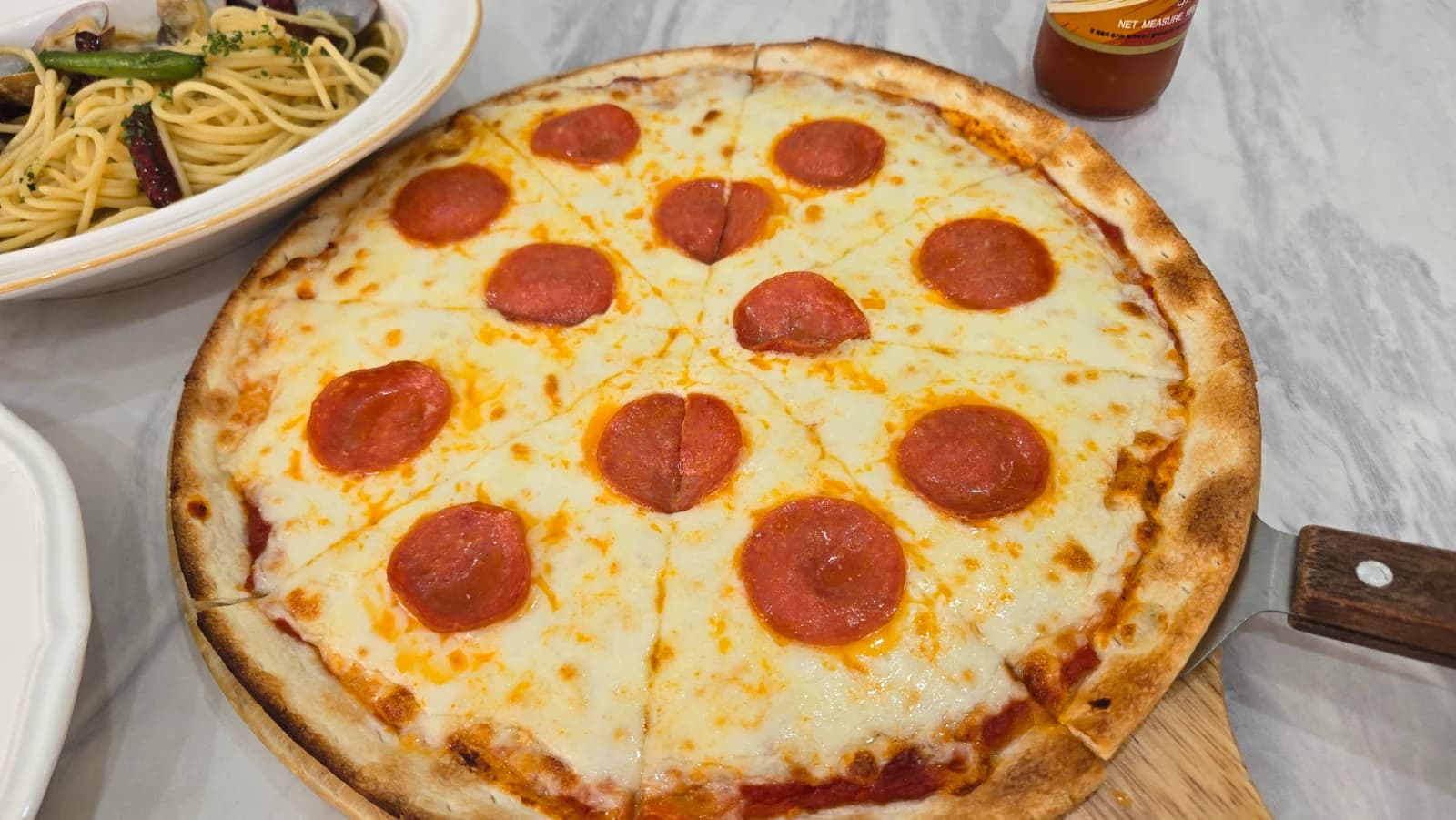 Full Mitaly pepperoni pizza with thin crust, melted cheese, and pepperoni slices