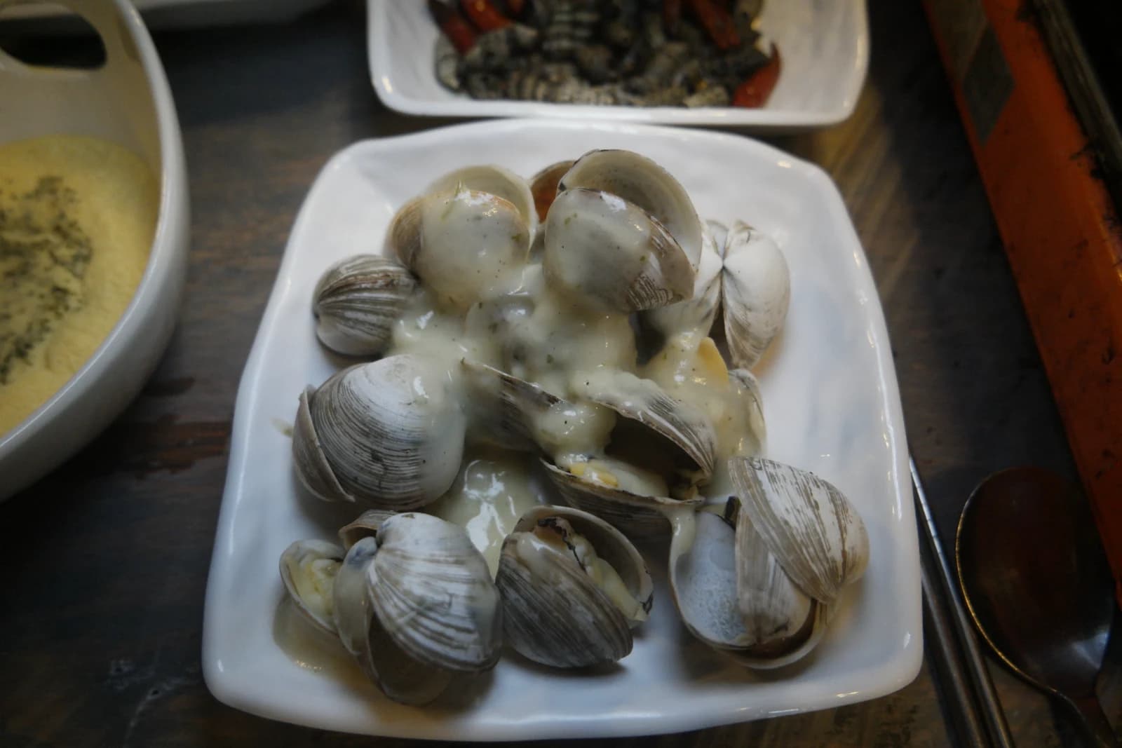 Cream sauce clam side dish served before mulhoe at a Korean seafood restaurant
