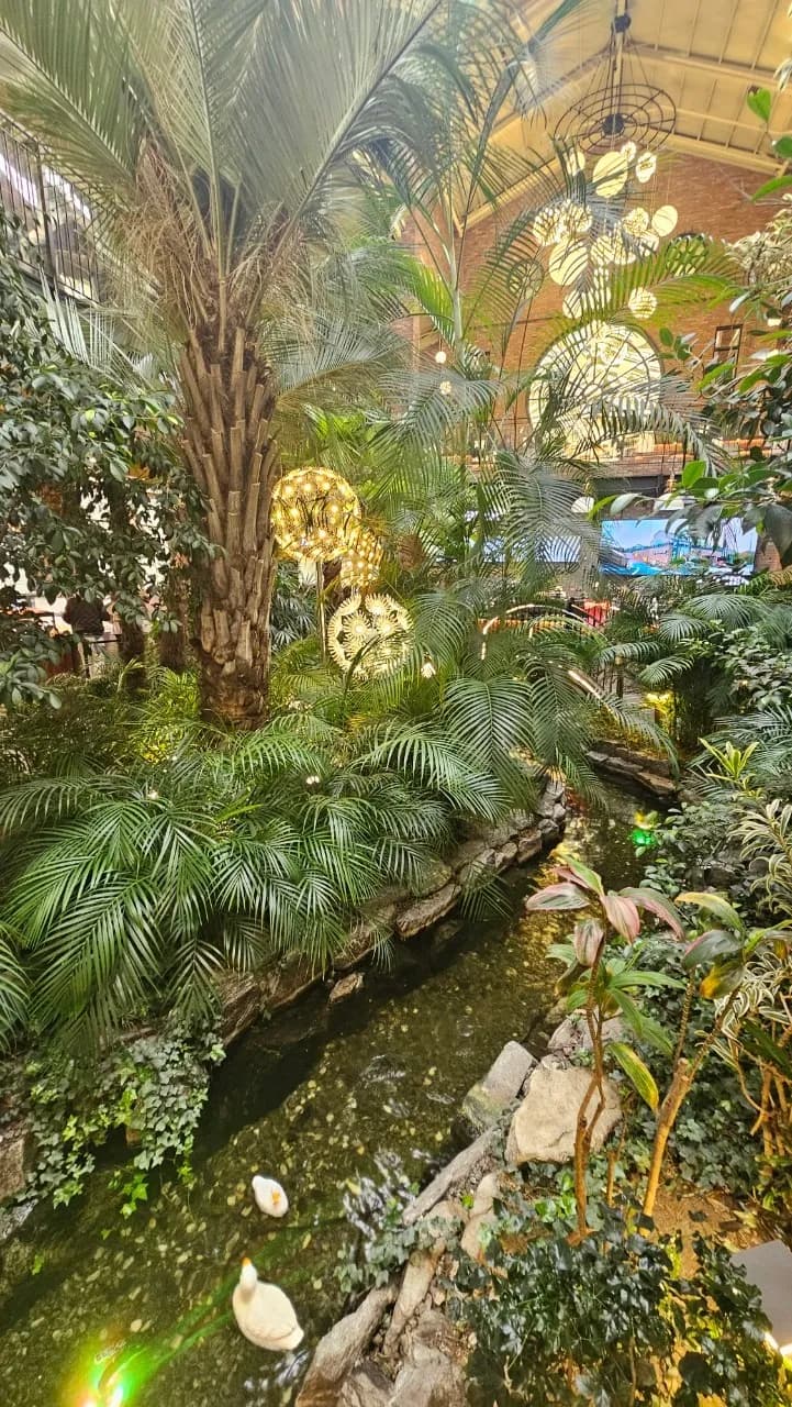 포레스트 아웃팅스 연못 앞에서 바라본 계단 좌석과 천장 꽃 조형물 전경 | 하이제이에스비