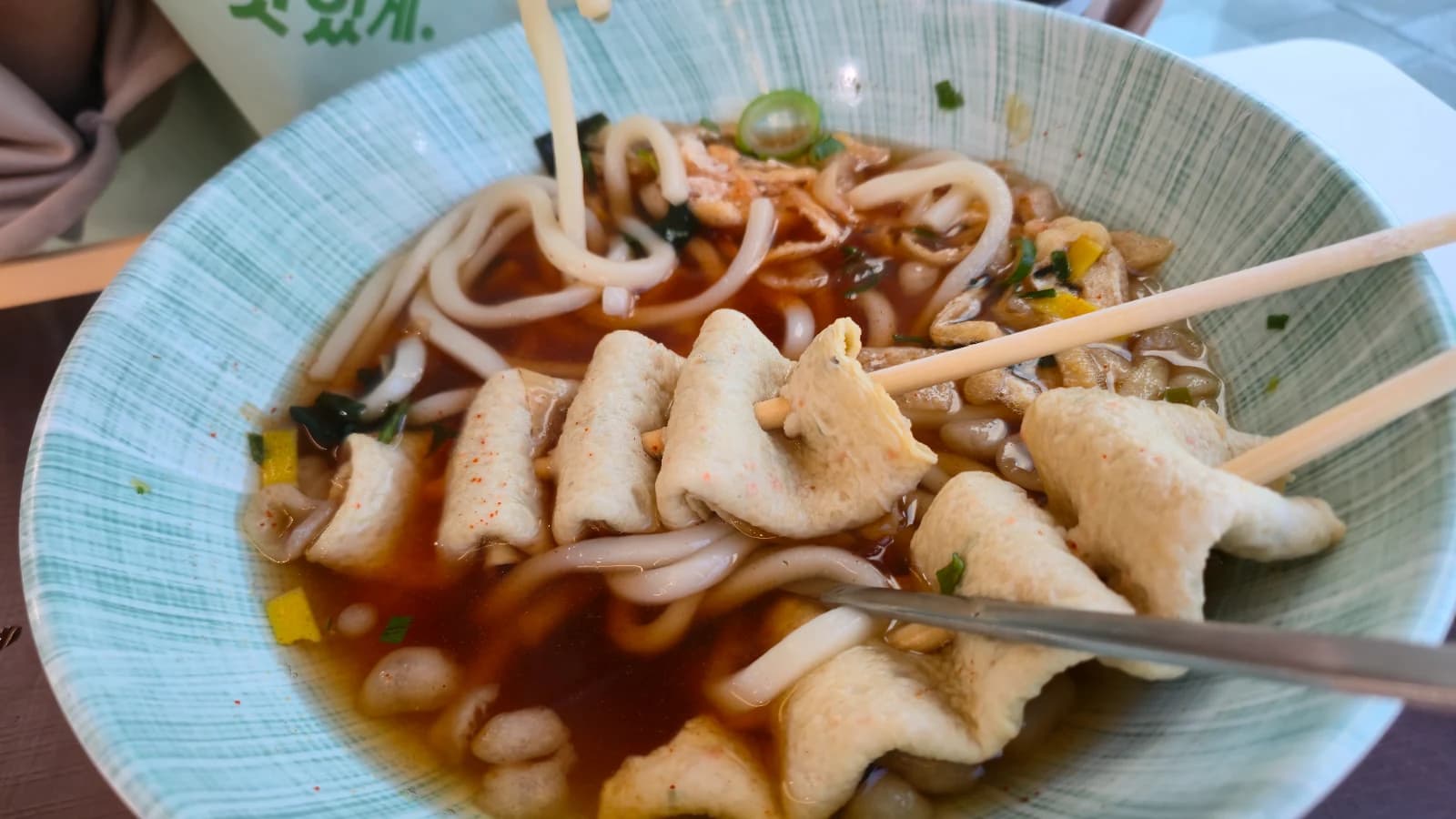 Abalone fish cake skewer udon — thick noodles in clear broth