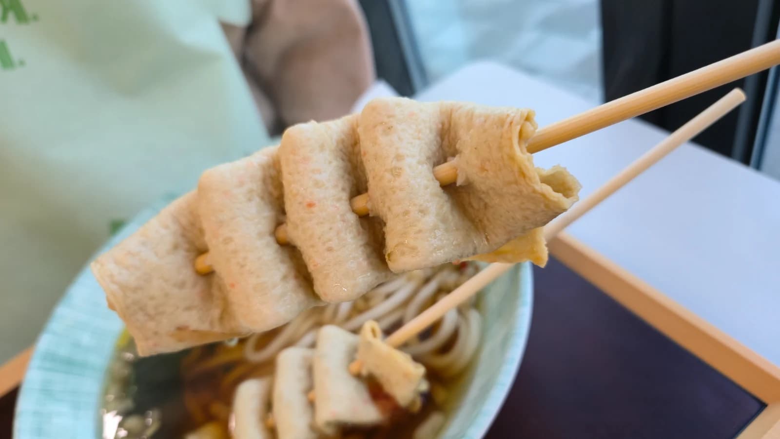 Close-up of fish cake skewers — pressed fish cake chunks on a stick