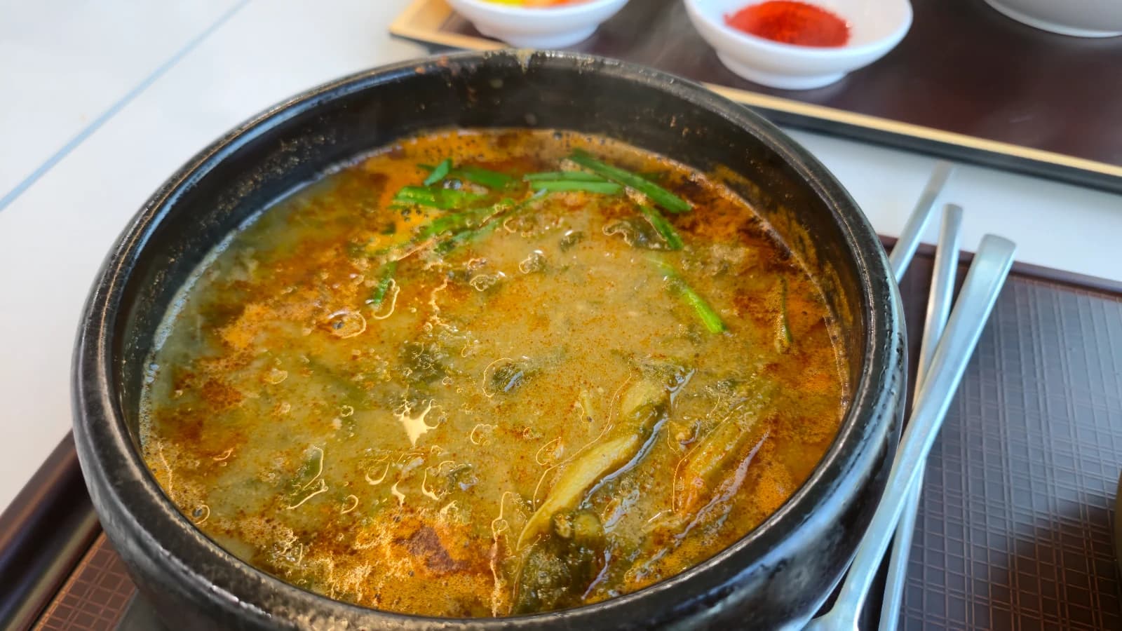 Yihaeyun chueotang close-up — thick dark broth with ground loach